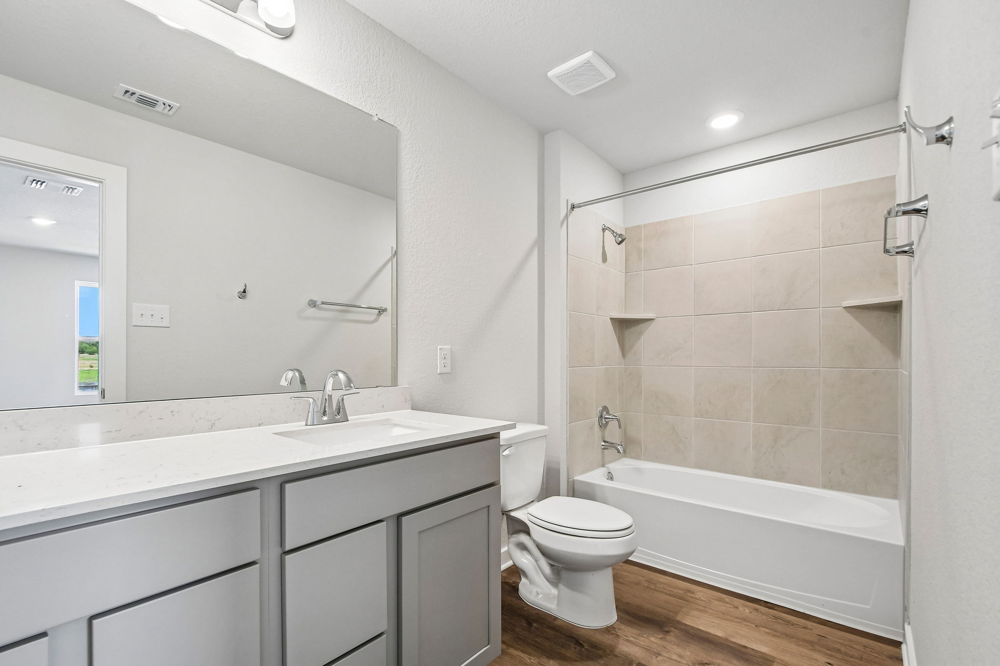 A bathroom with a tub toilet and sink.