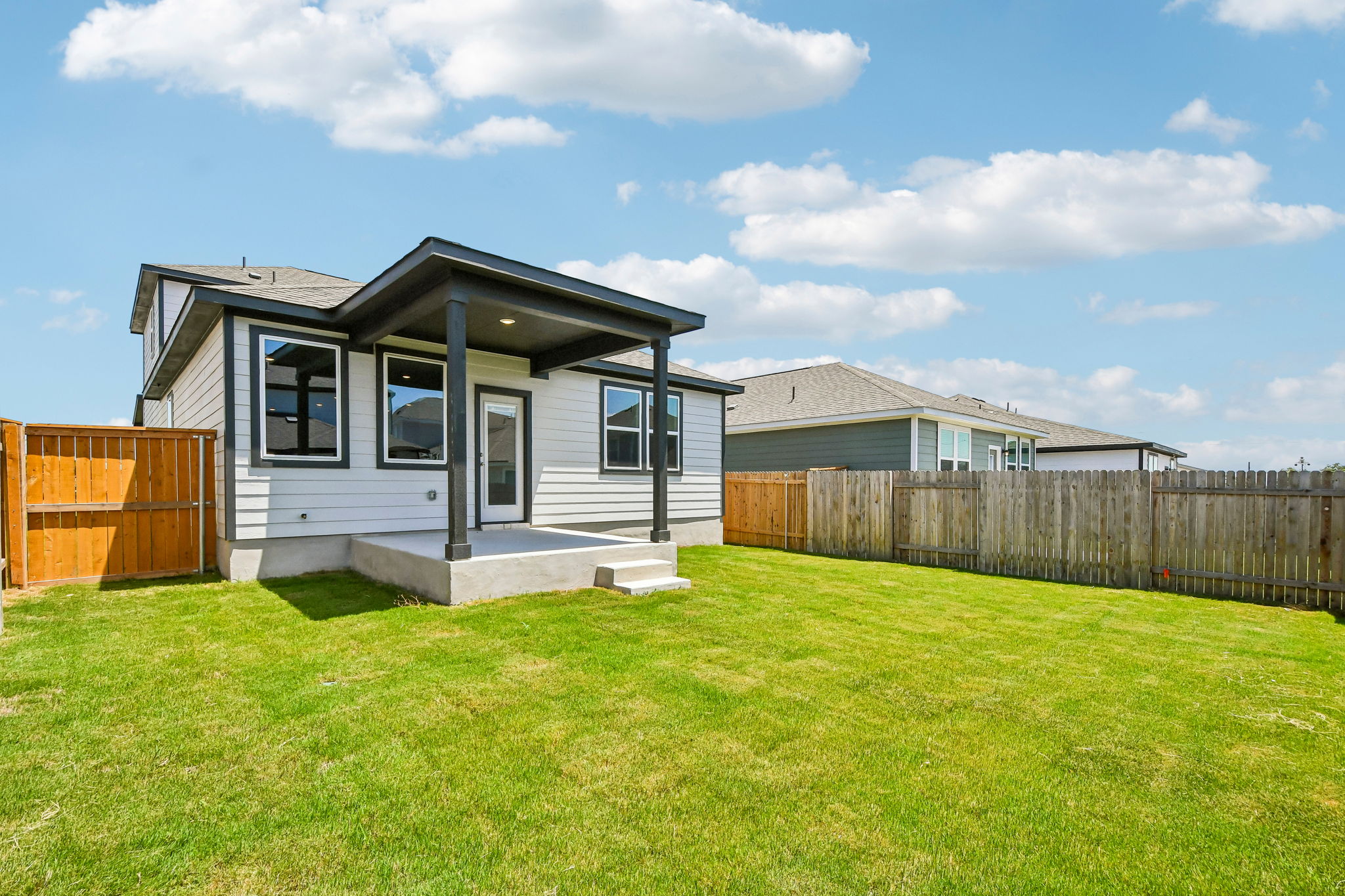 A house with a fence and grass.