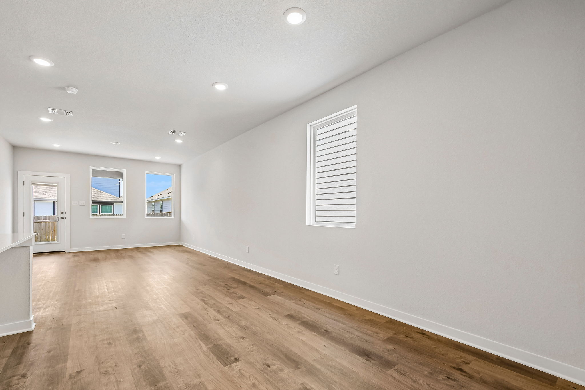 A room with a wood floor and white walls.