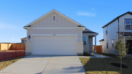A white garage with a fence.