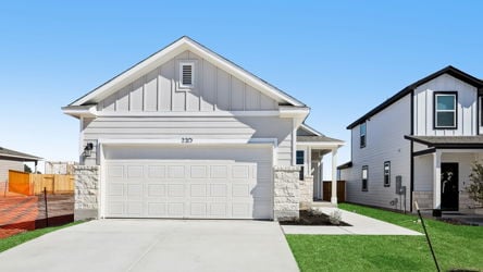 A white house with a garage.