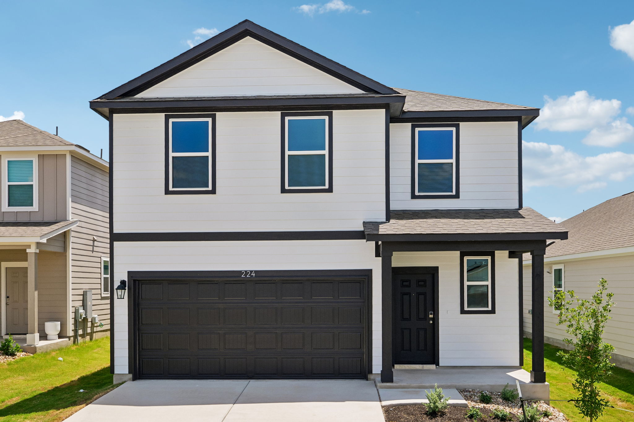 A grey house with a garage.