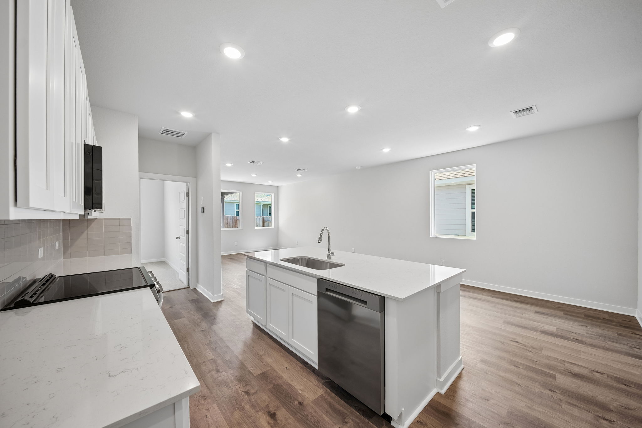 A kitchen with white cabinets.