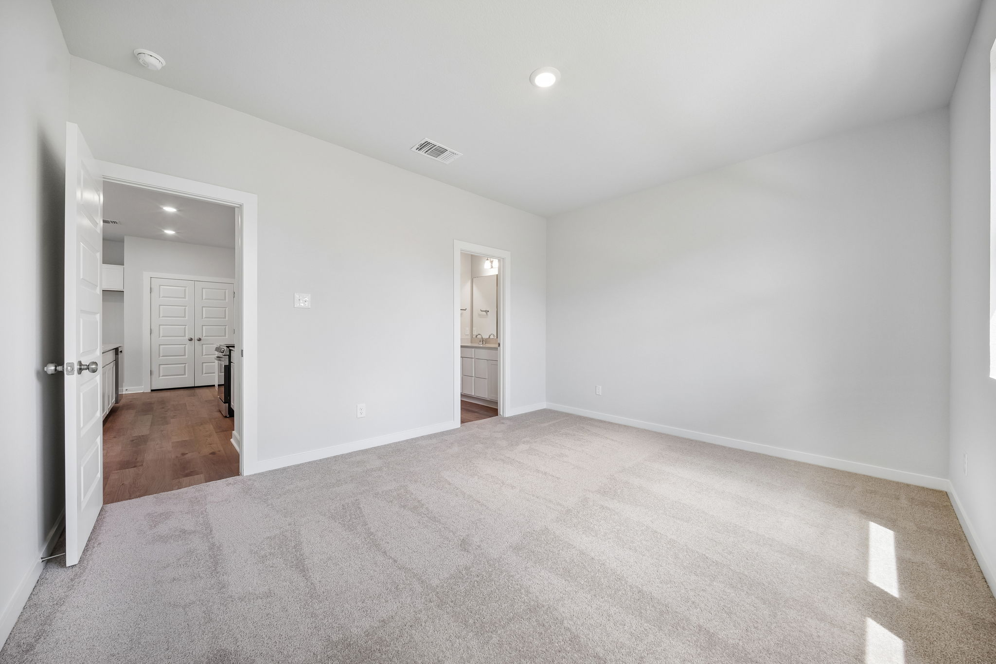 A long hallway with white walls.