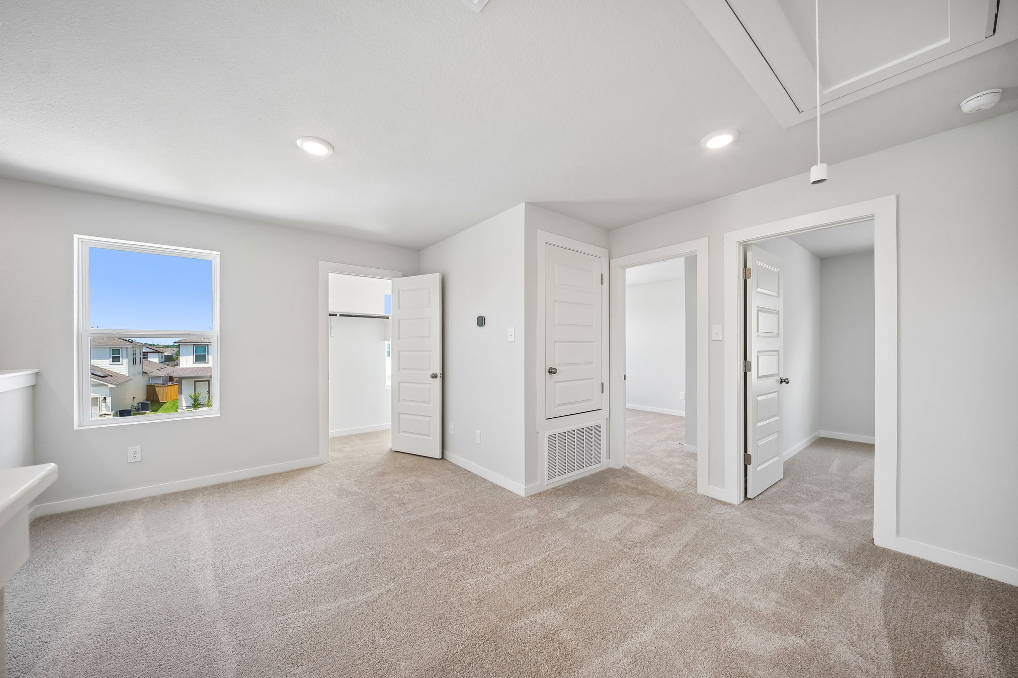 A room with white cabinets.