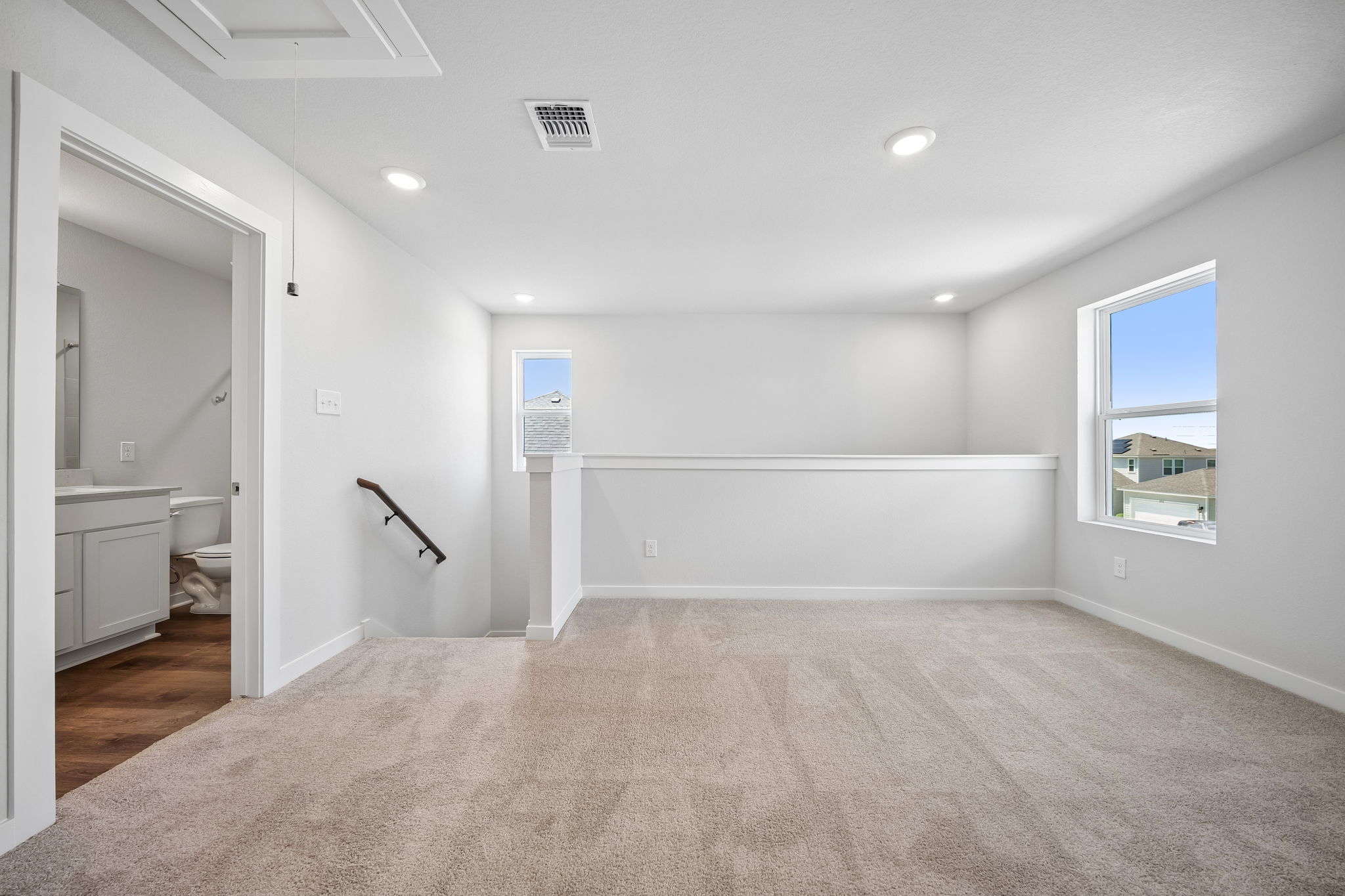 A room with a carpet and a window.
