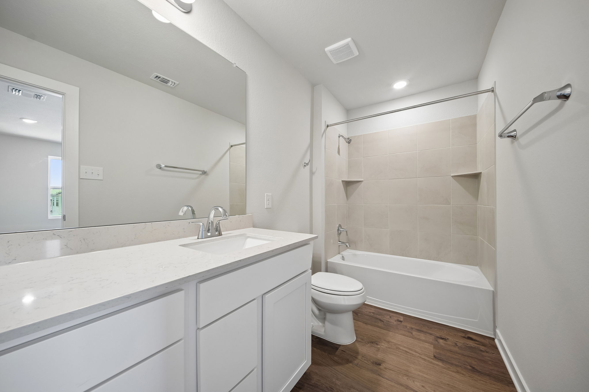 A bathroom with a tub sink and toilet.