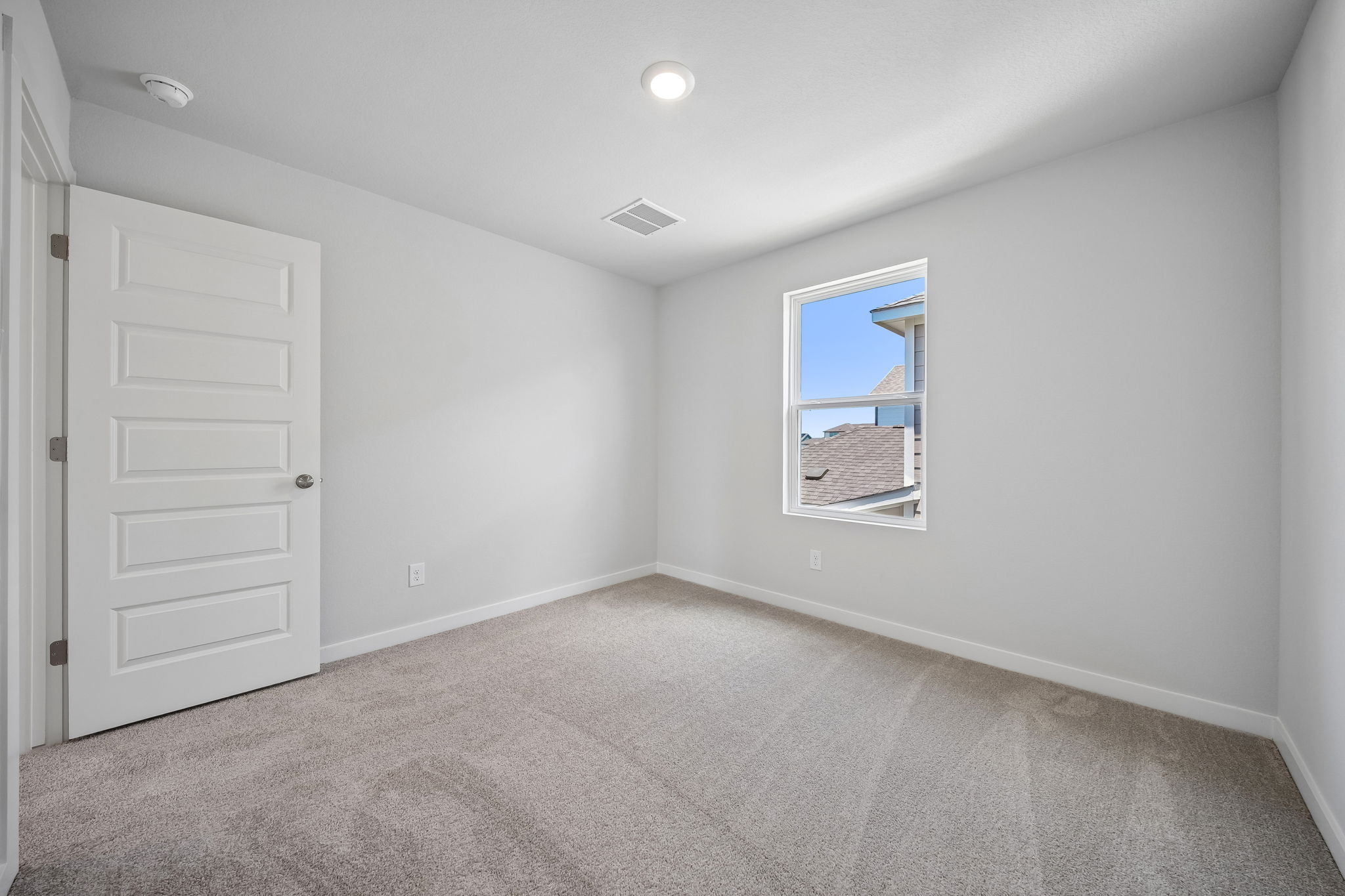 A room with a window and a door.