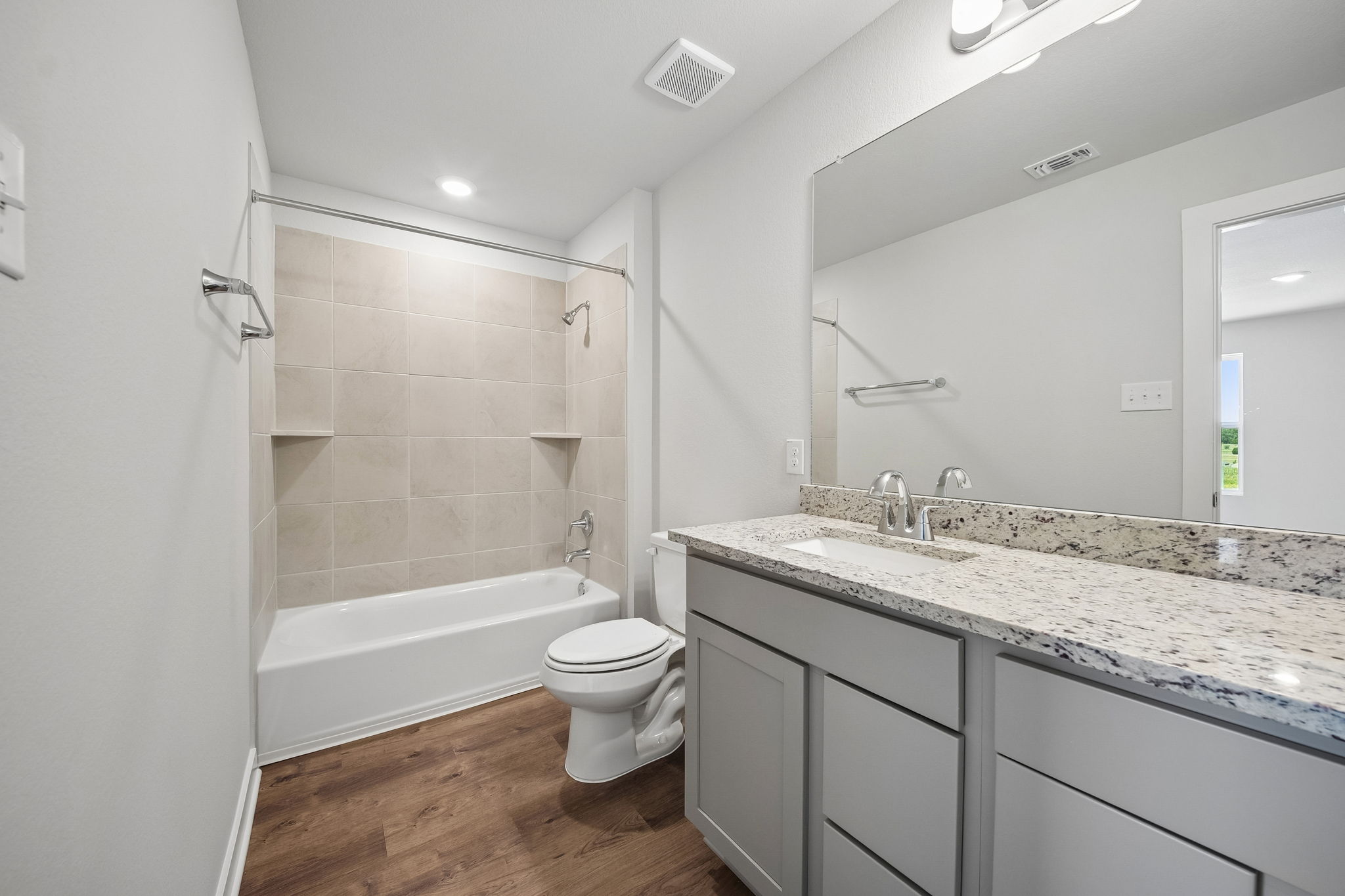A bathroom with a marble countertop.