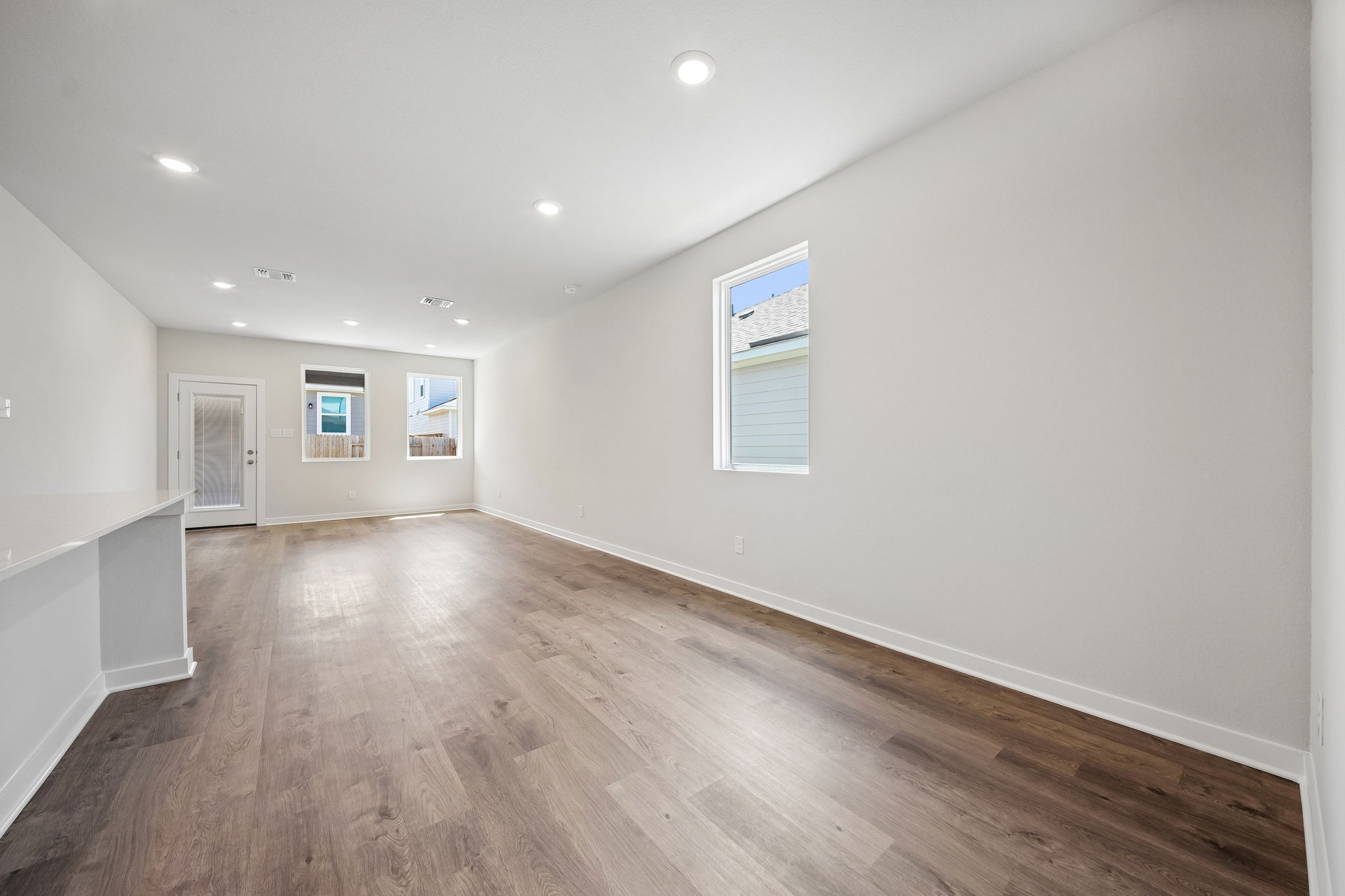 A room with a wood floor and white walls.