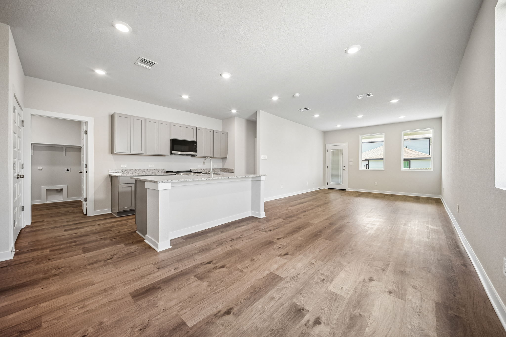 A large kitchen with white cabinets.