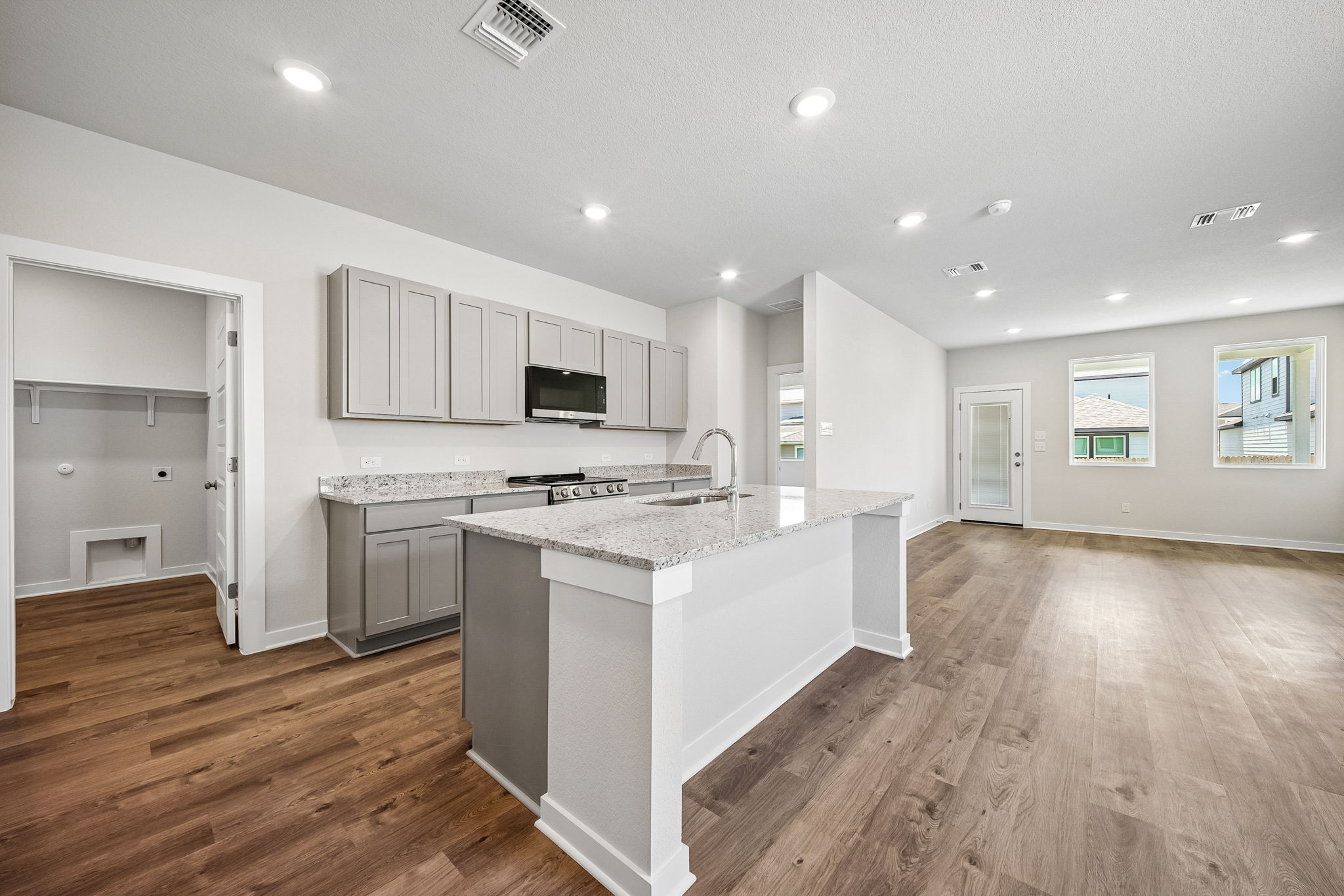 A kitchen with white cabinets.