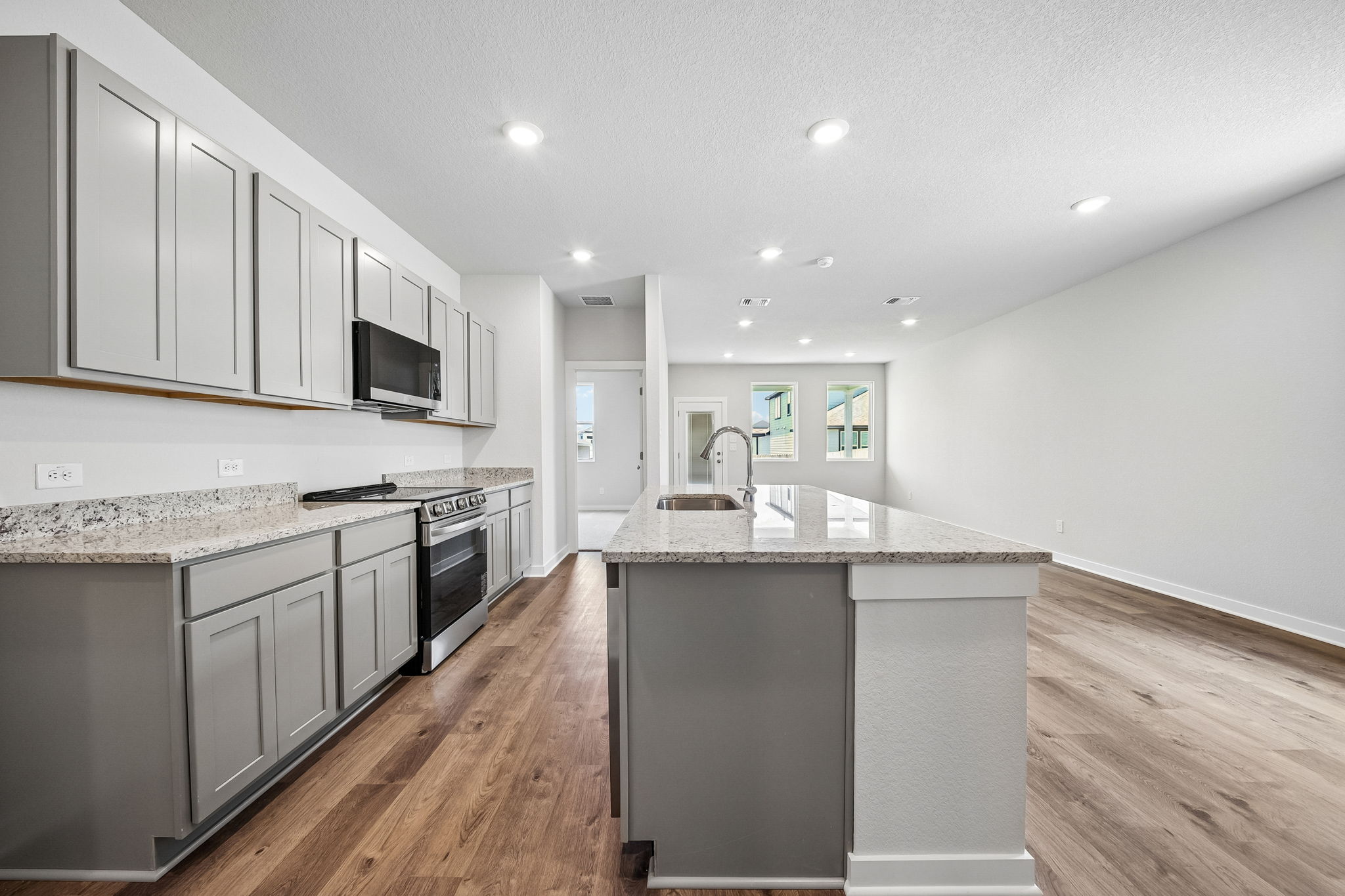 A kitchen with white cabinets.