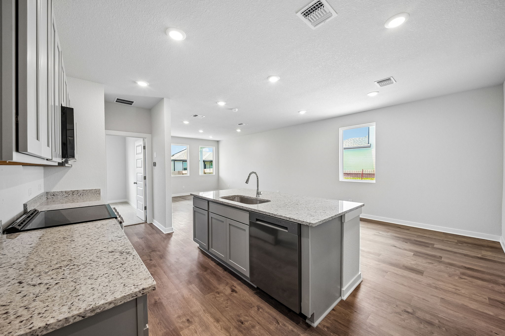 A kitchen with a wood floor.