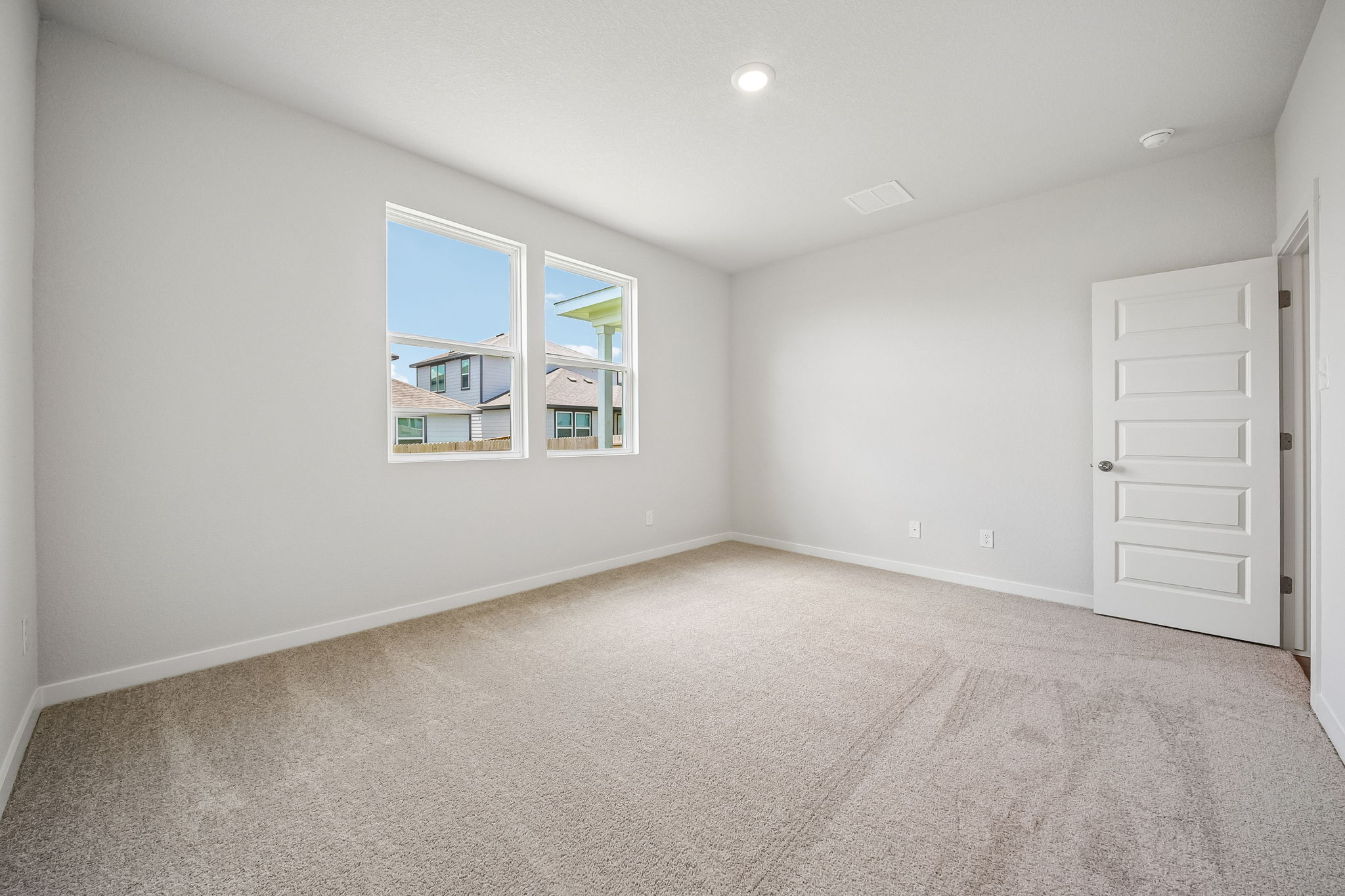 A room with white walls and a window.