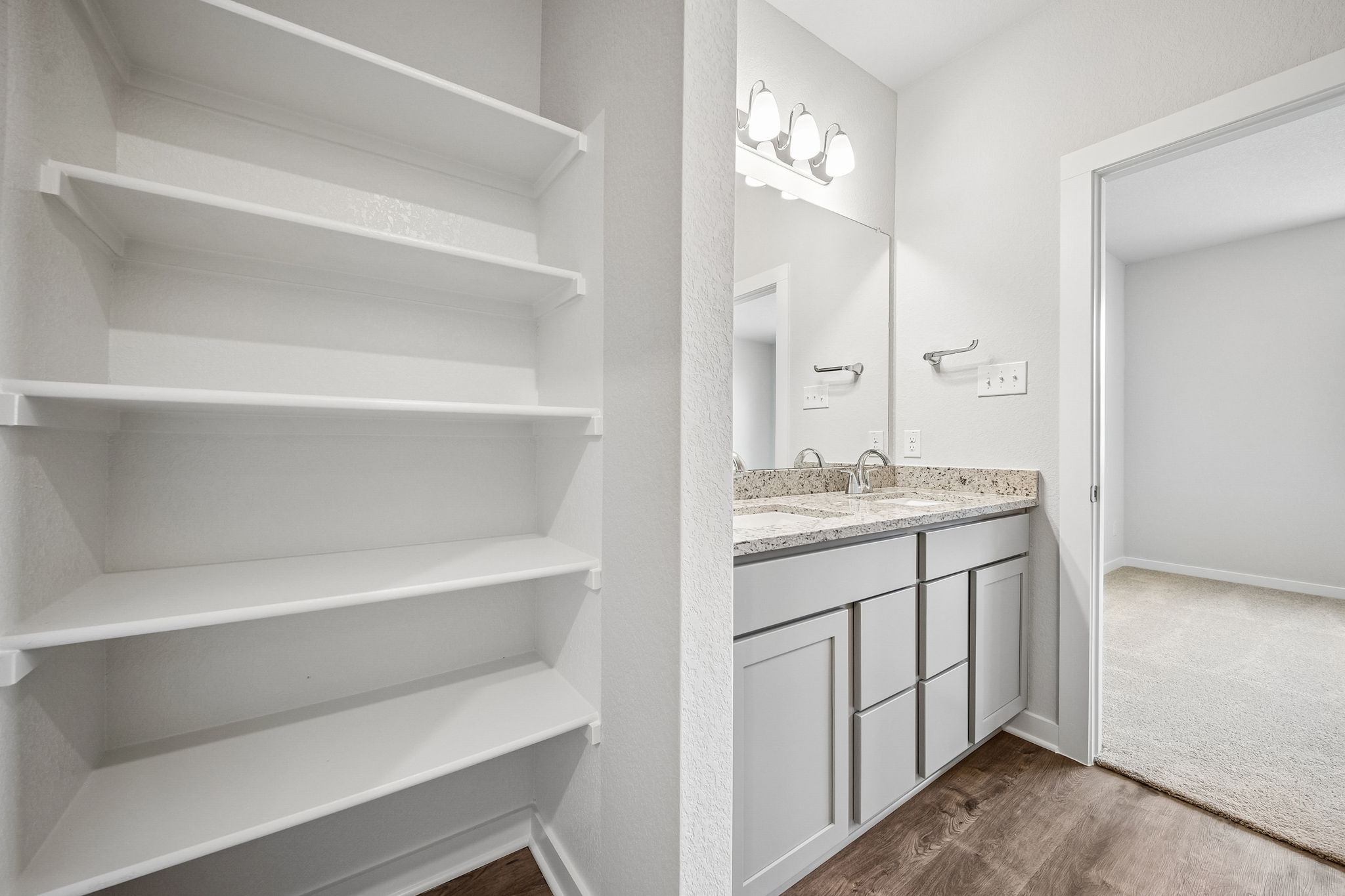 A bathroom with white cabinets.