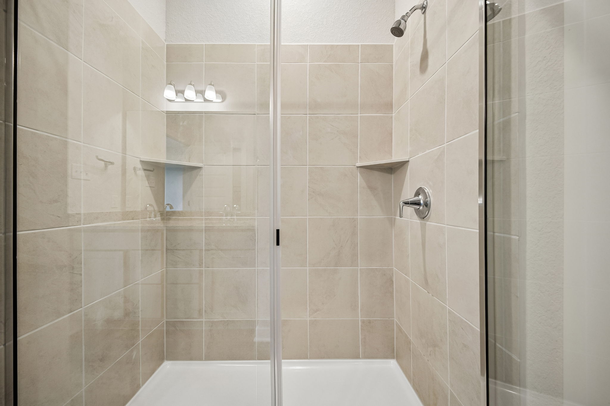 A shower with glass doors.