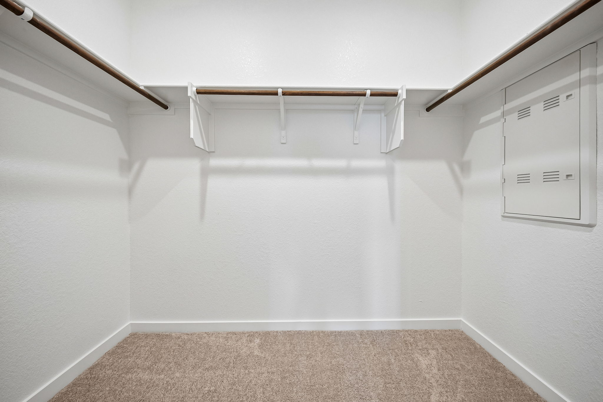 A white wall with a white door.
