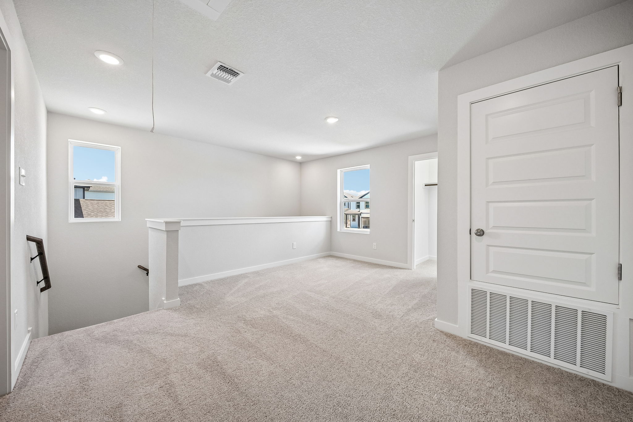 A room with white walls and a white bench.