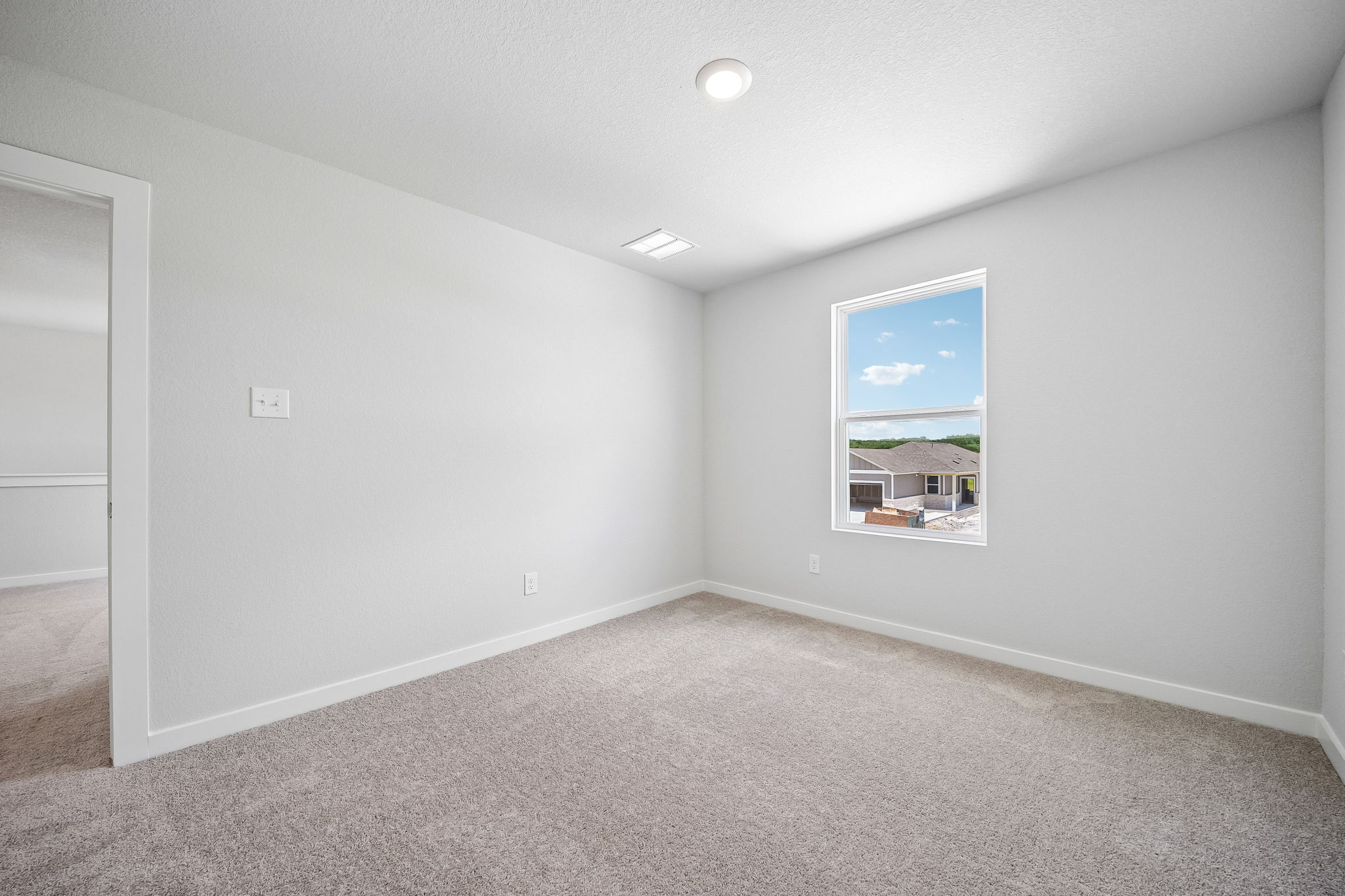 A room with a painting on the wall.
