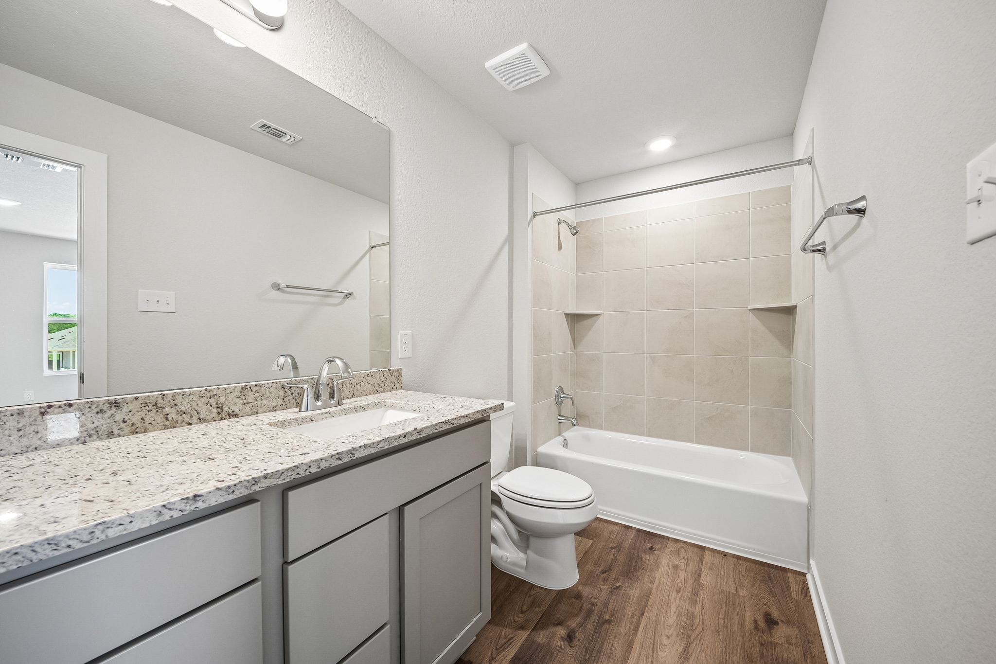 A bathroom with a marble countertop.