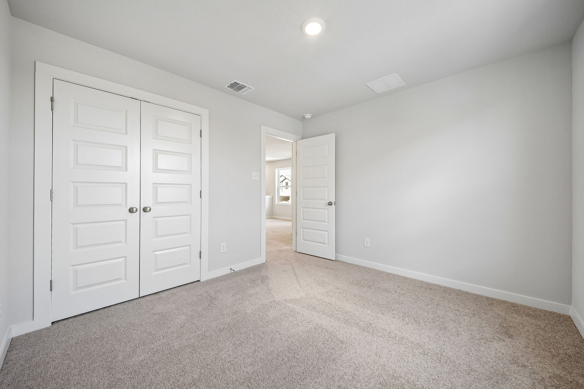 A hallway with white doors.