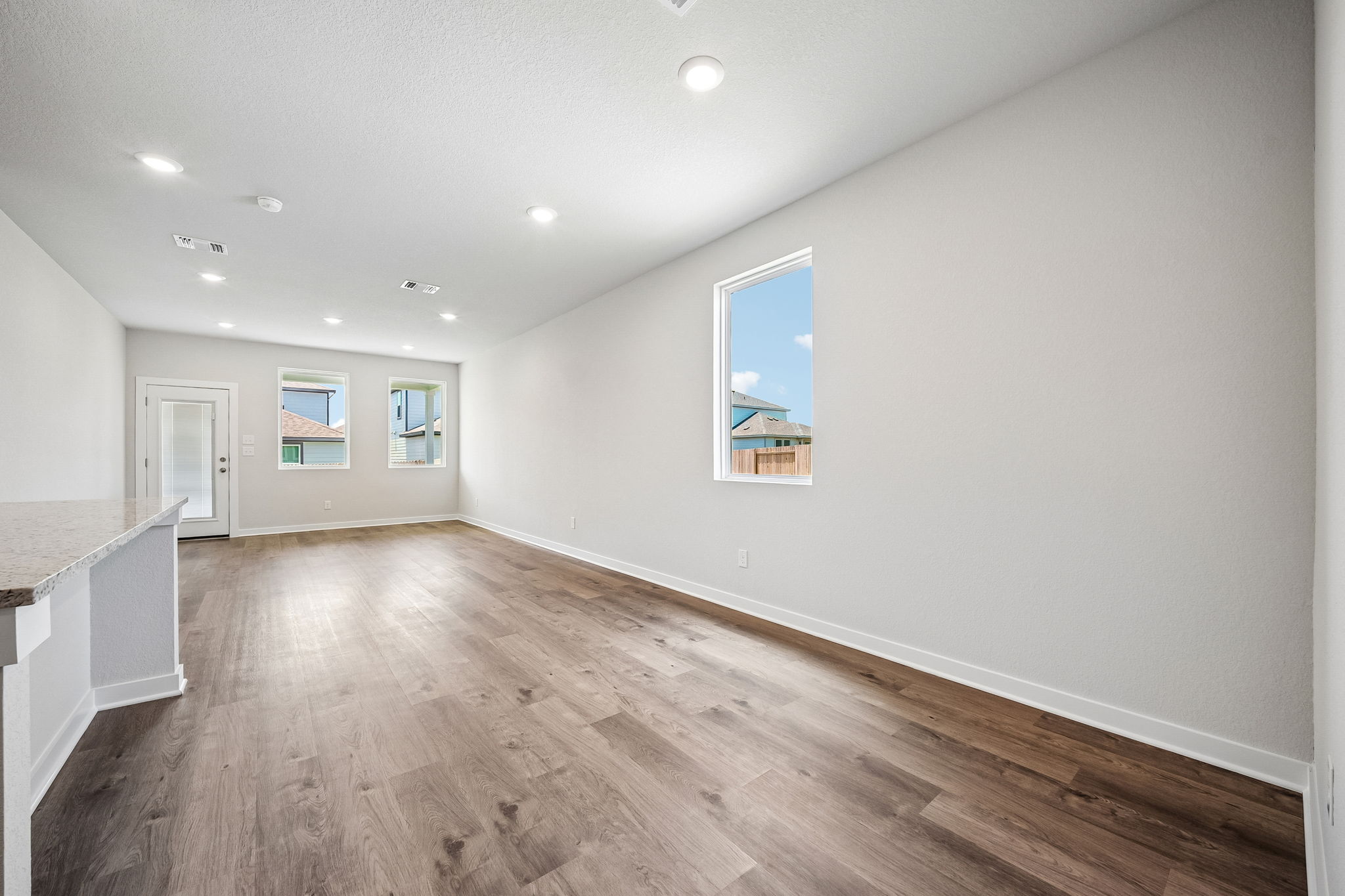 A room with a wood floor and a wood floor with a painting on the wall.