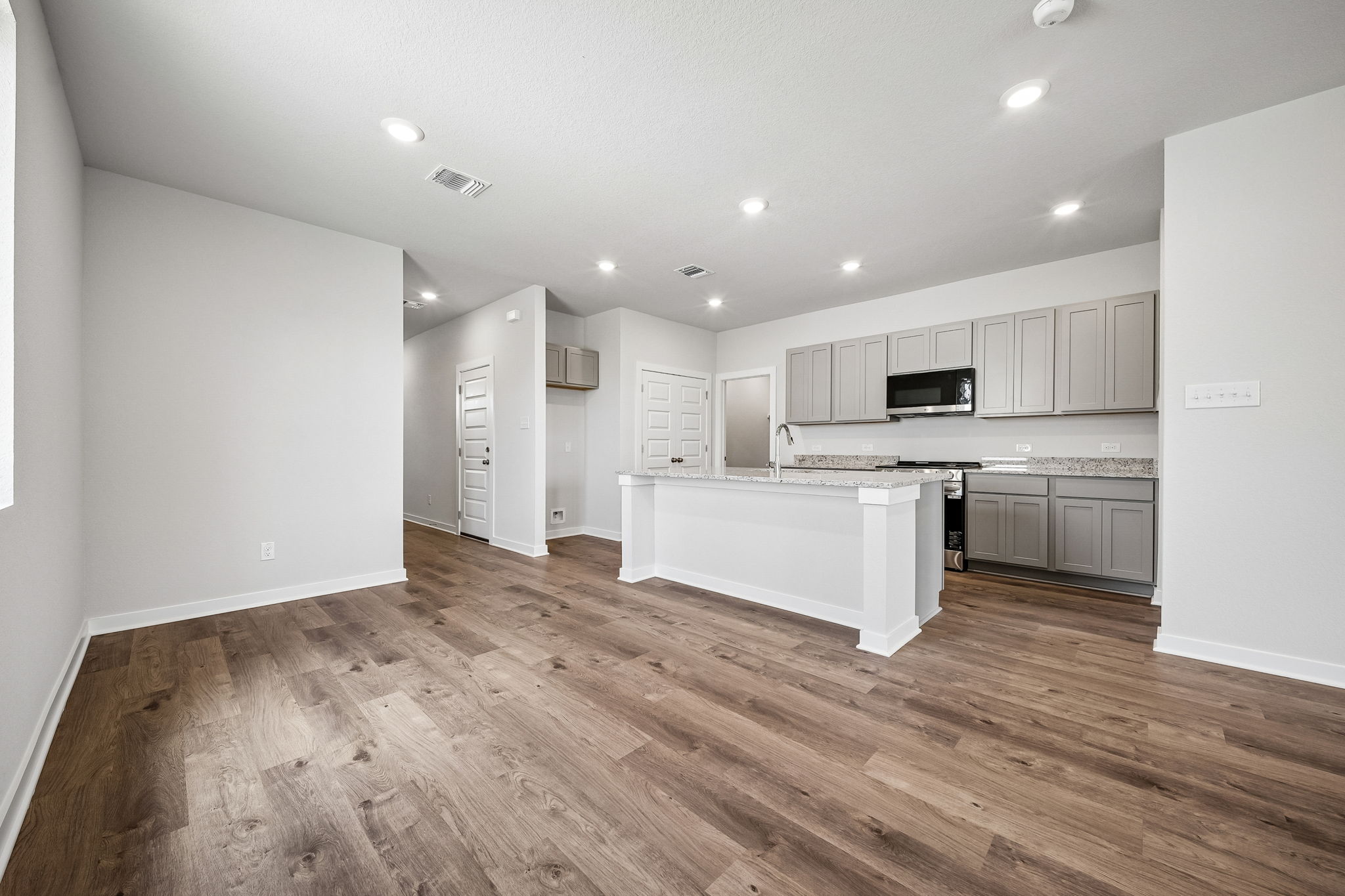 A kitchen with white cabinets.