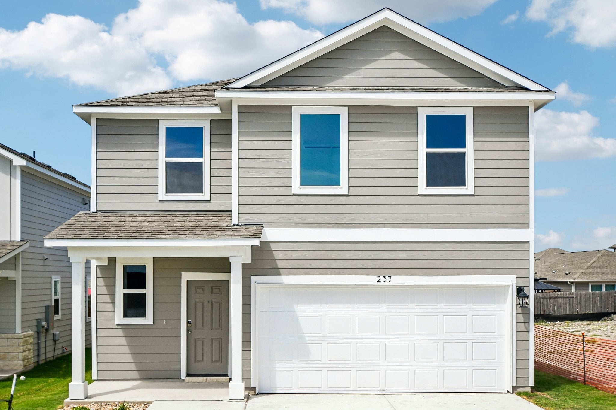 A white house with a garage.