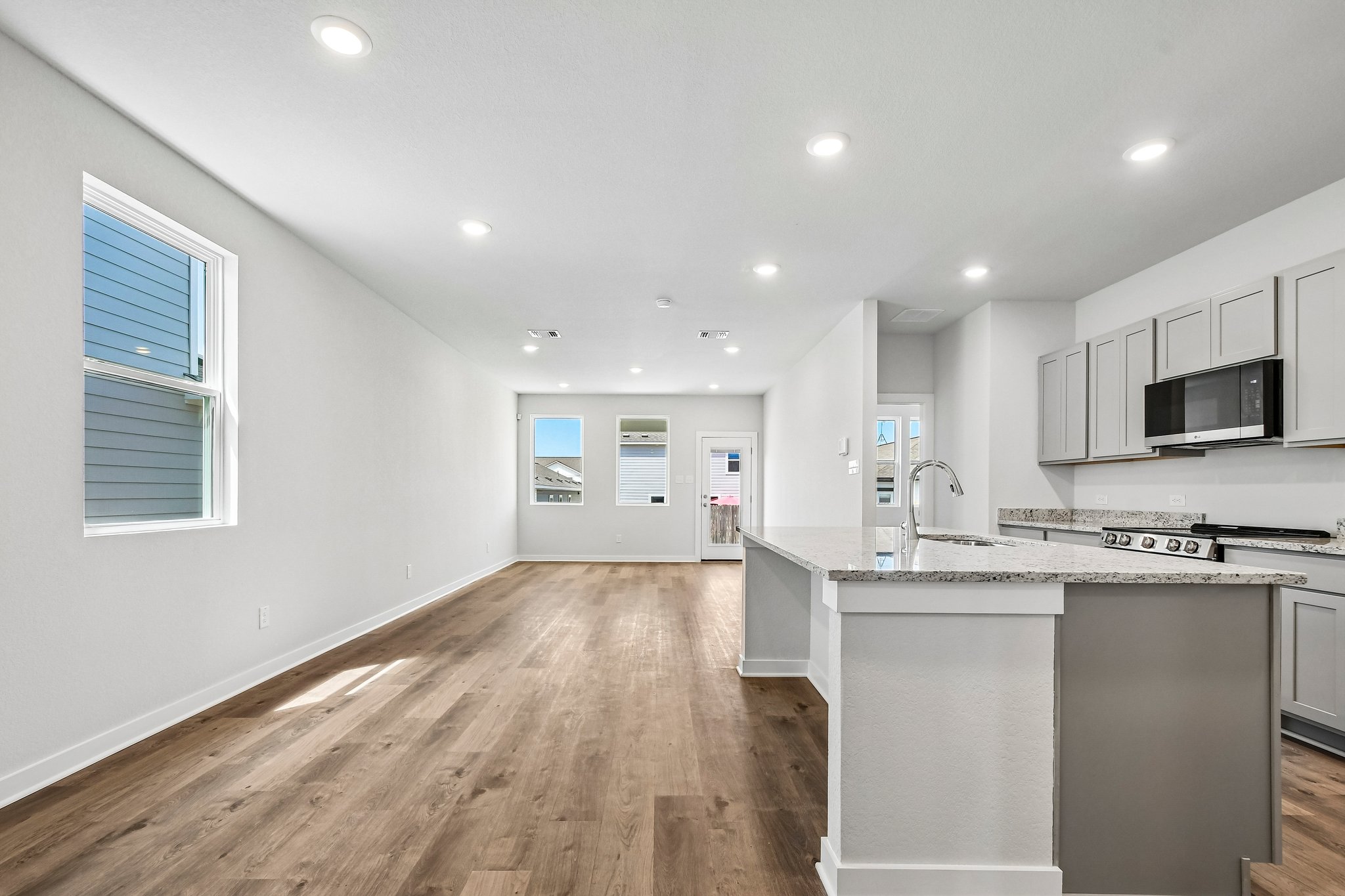 A kitchen with white cabinets.