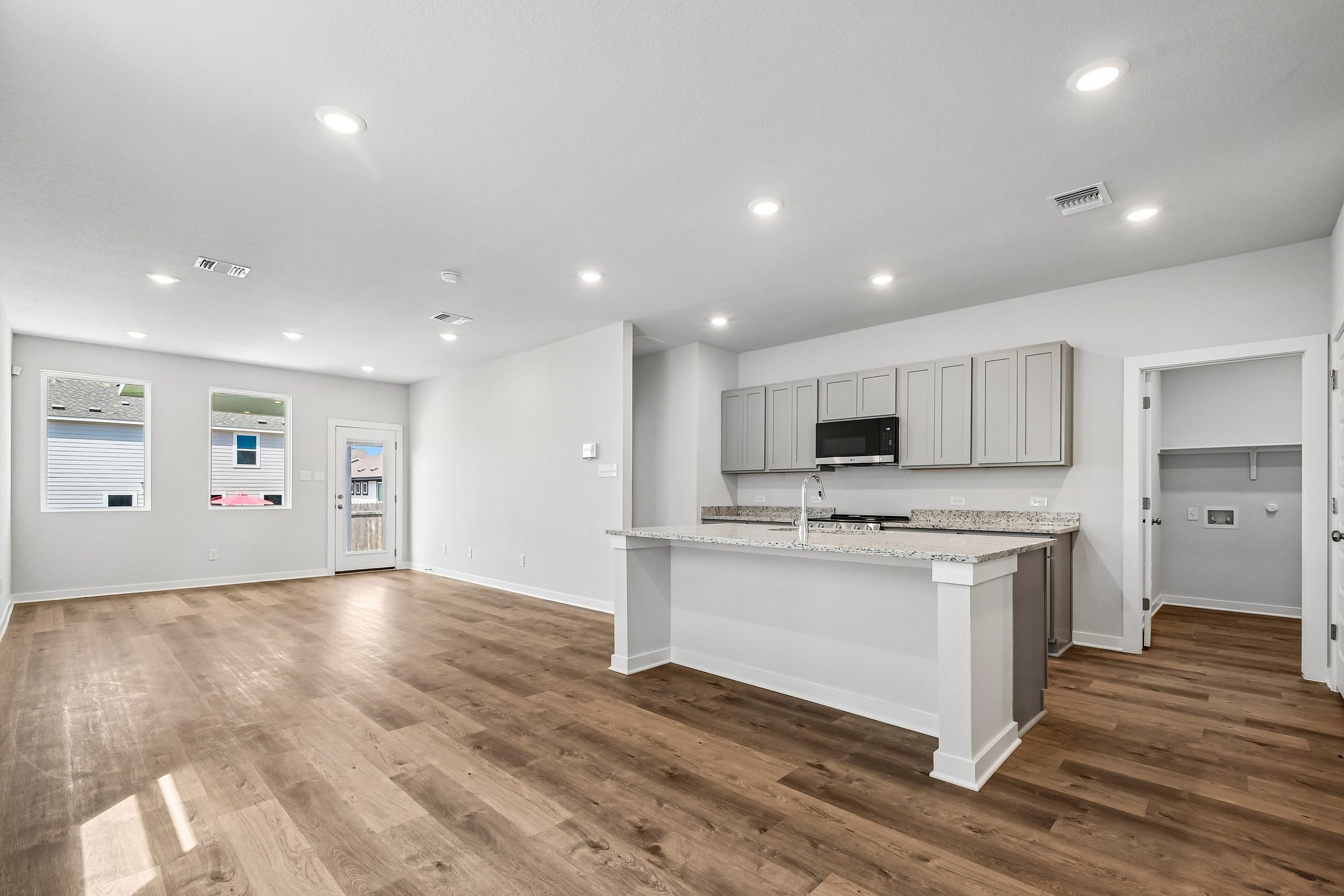A large kitchen with white cabinets.