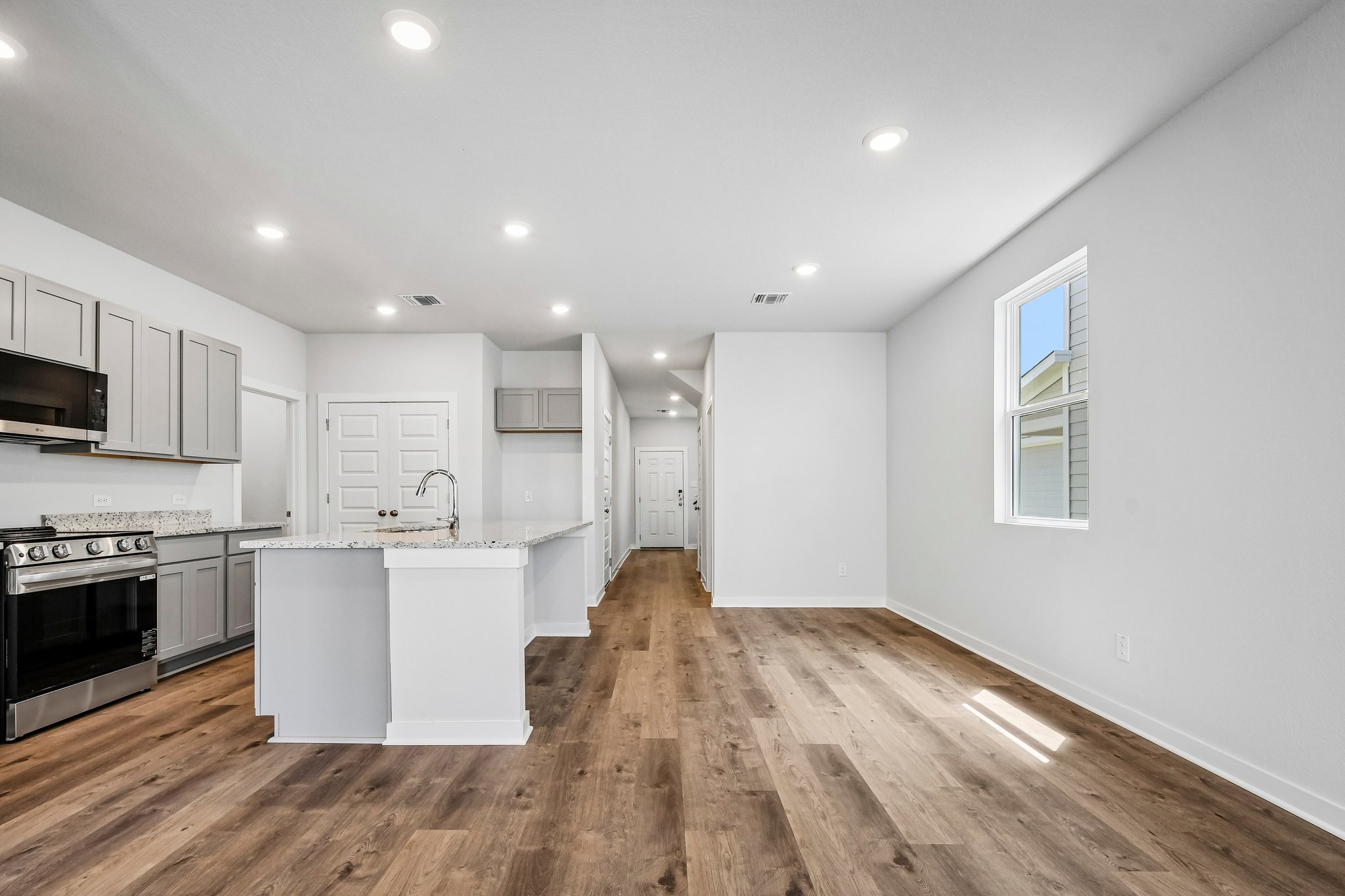 A kitchen with white cabinets.