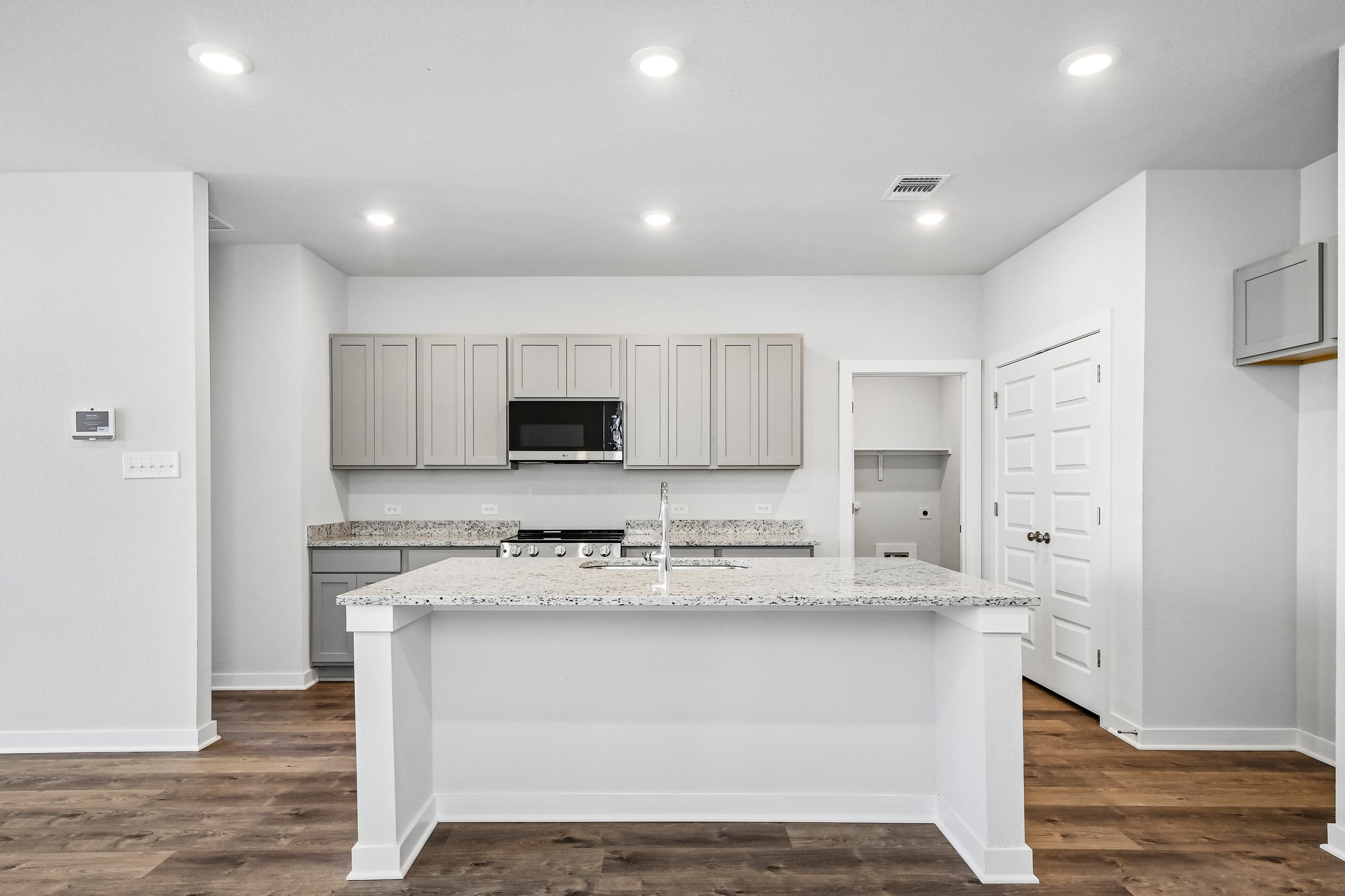 A kitchen with white cabinets.