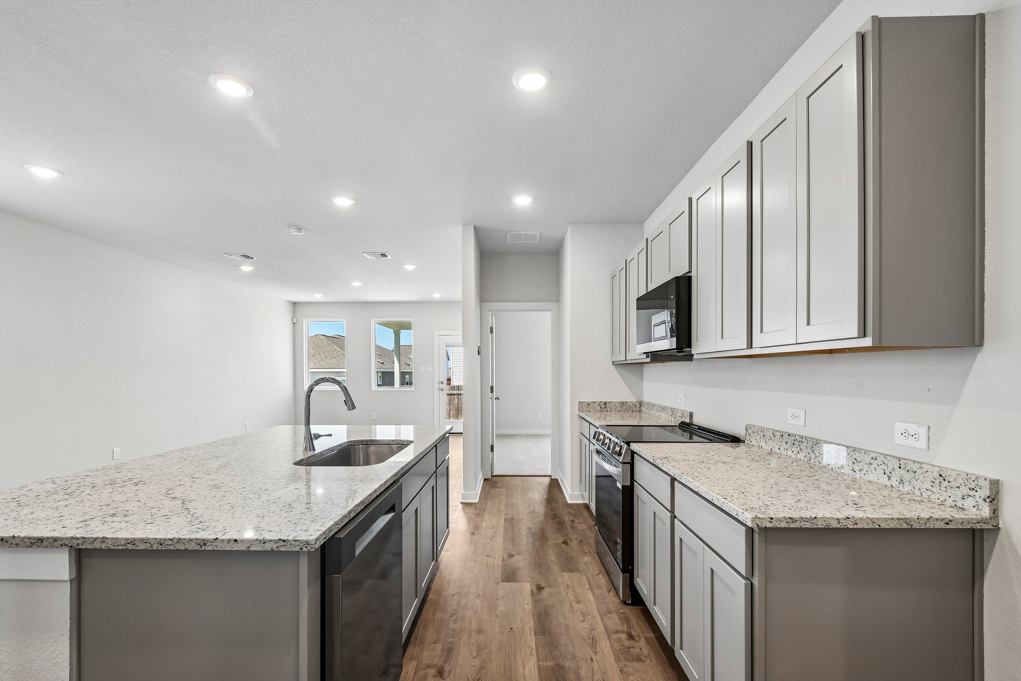 A kitchen with marble counters.
