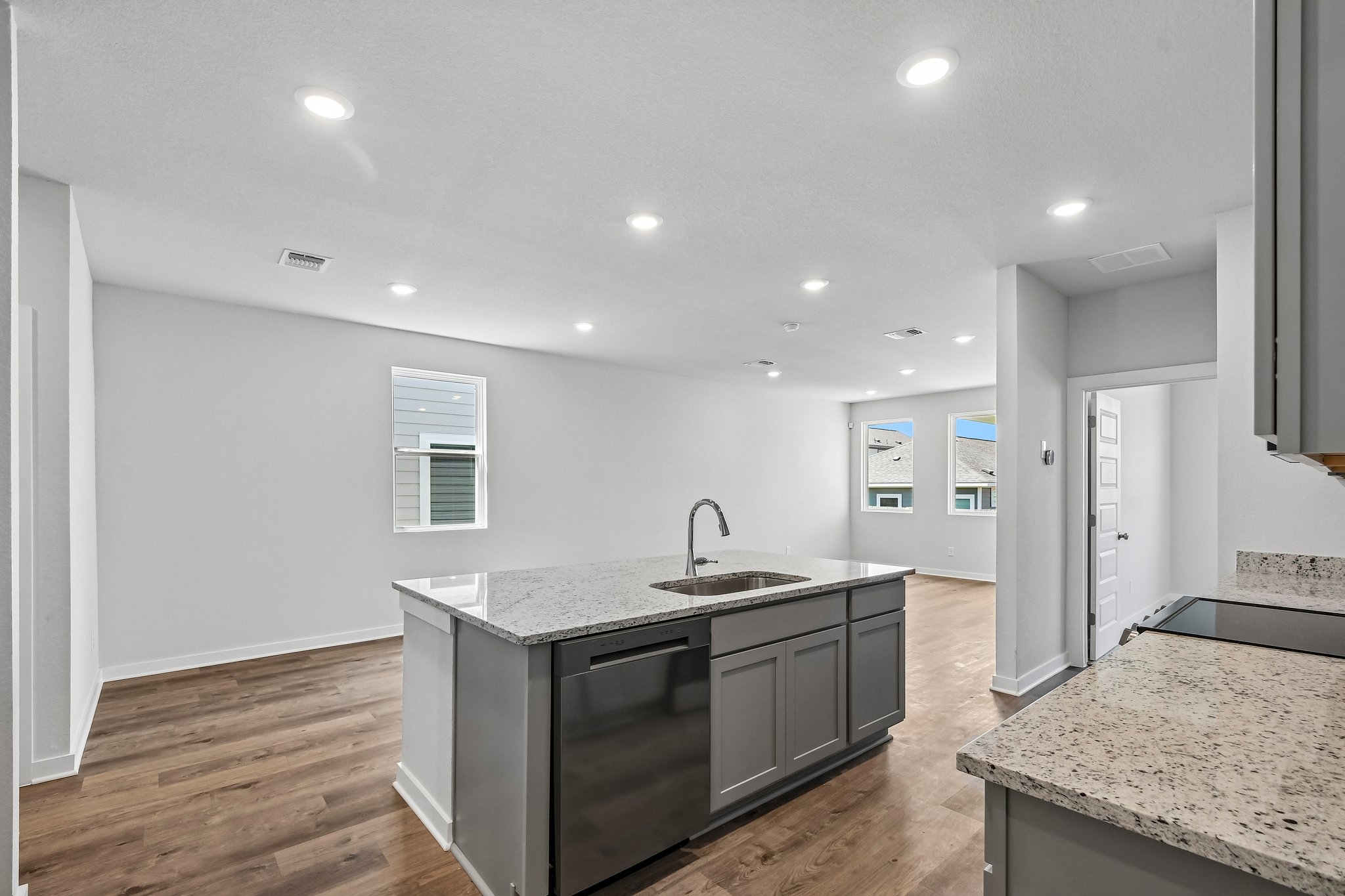 A kitchen with a marble counter top.