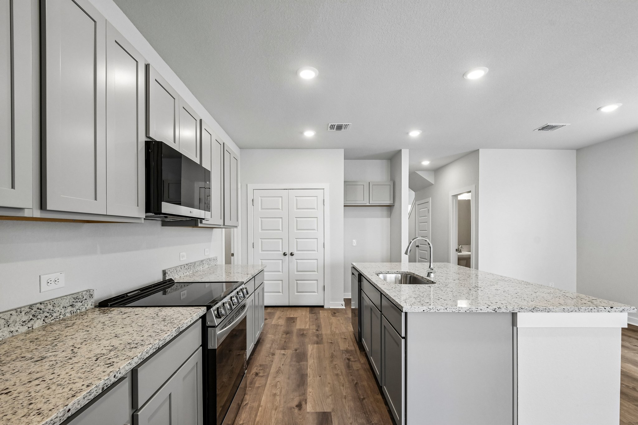 A kitchen with white cabinets.
