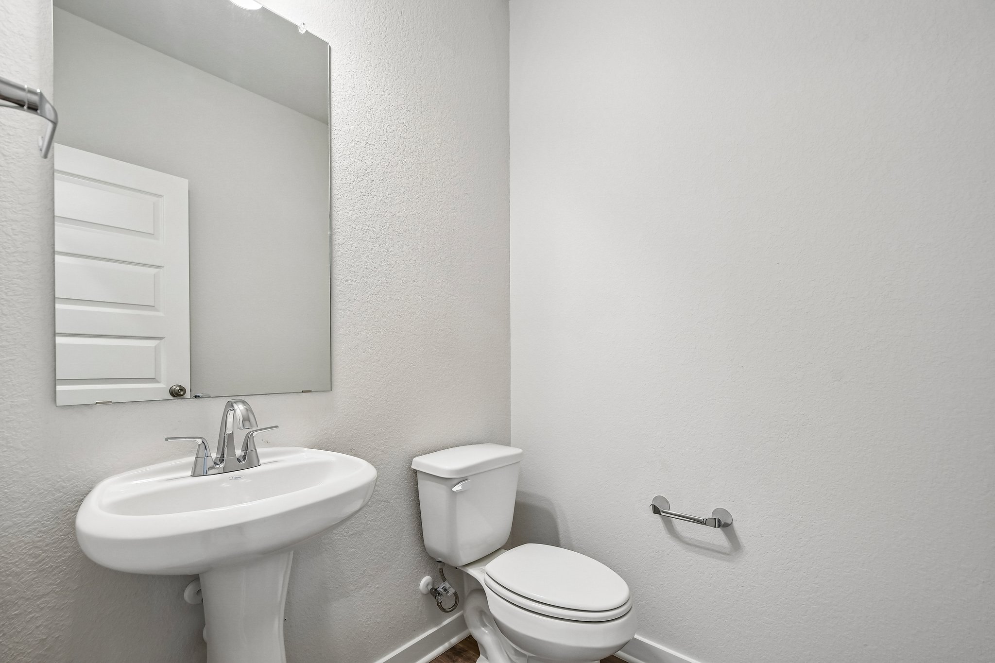 A bathroom with a toilet and sink.