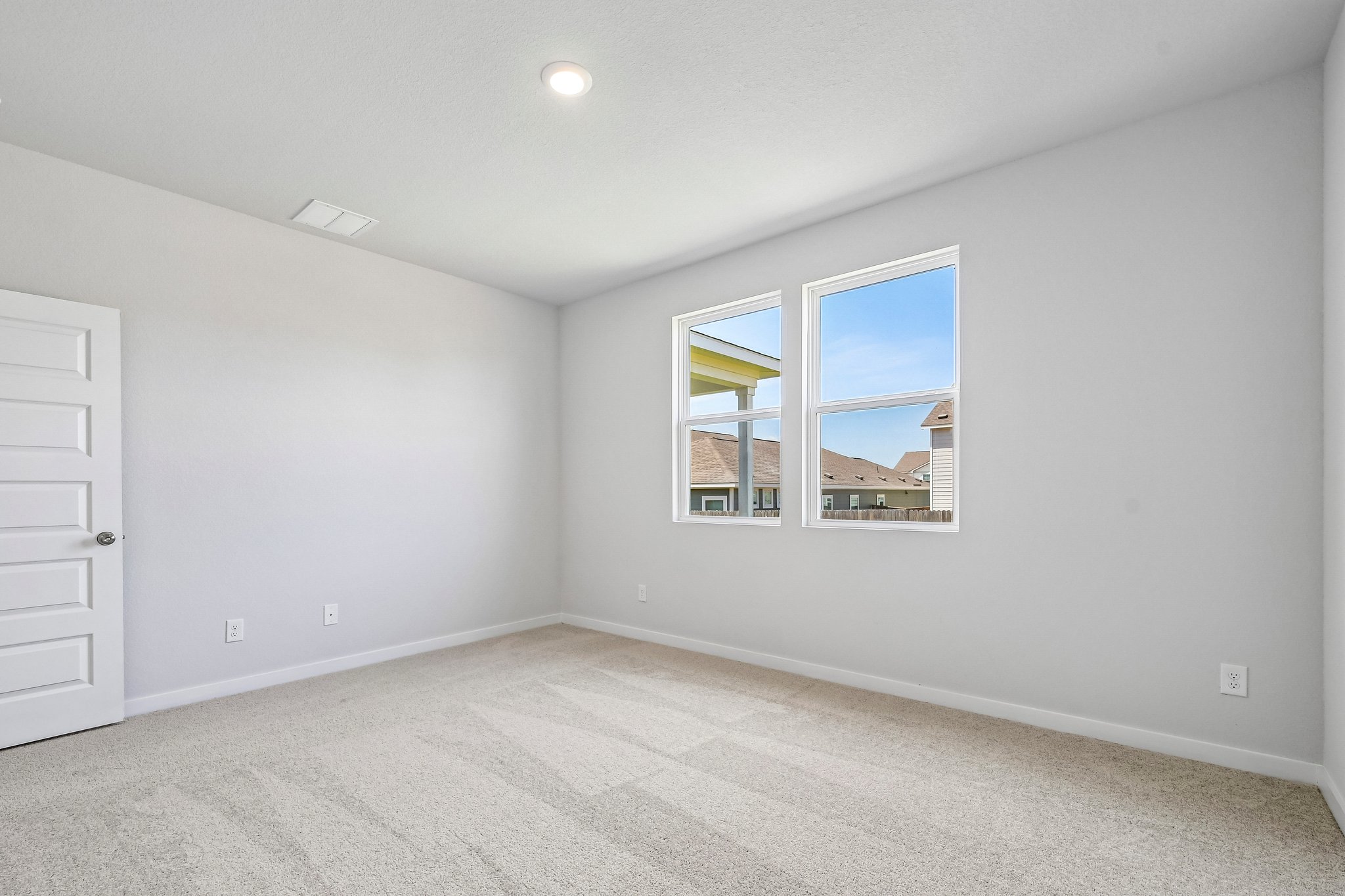 A room with a window and a door.