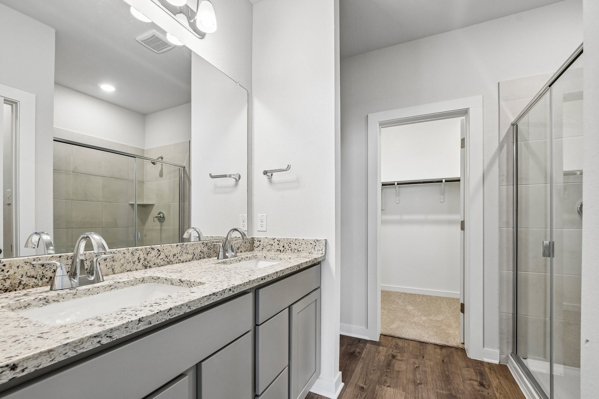 A bathroom with a large mirror.