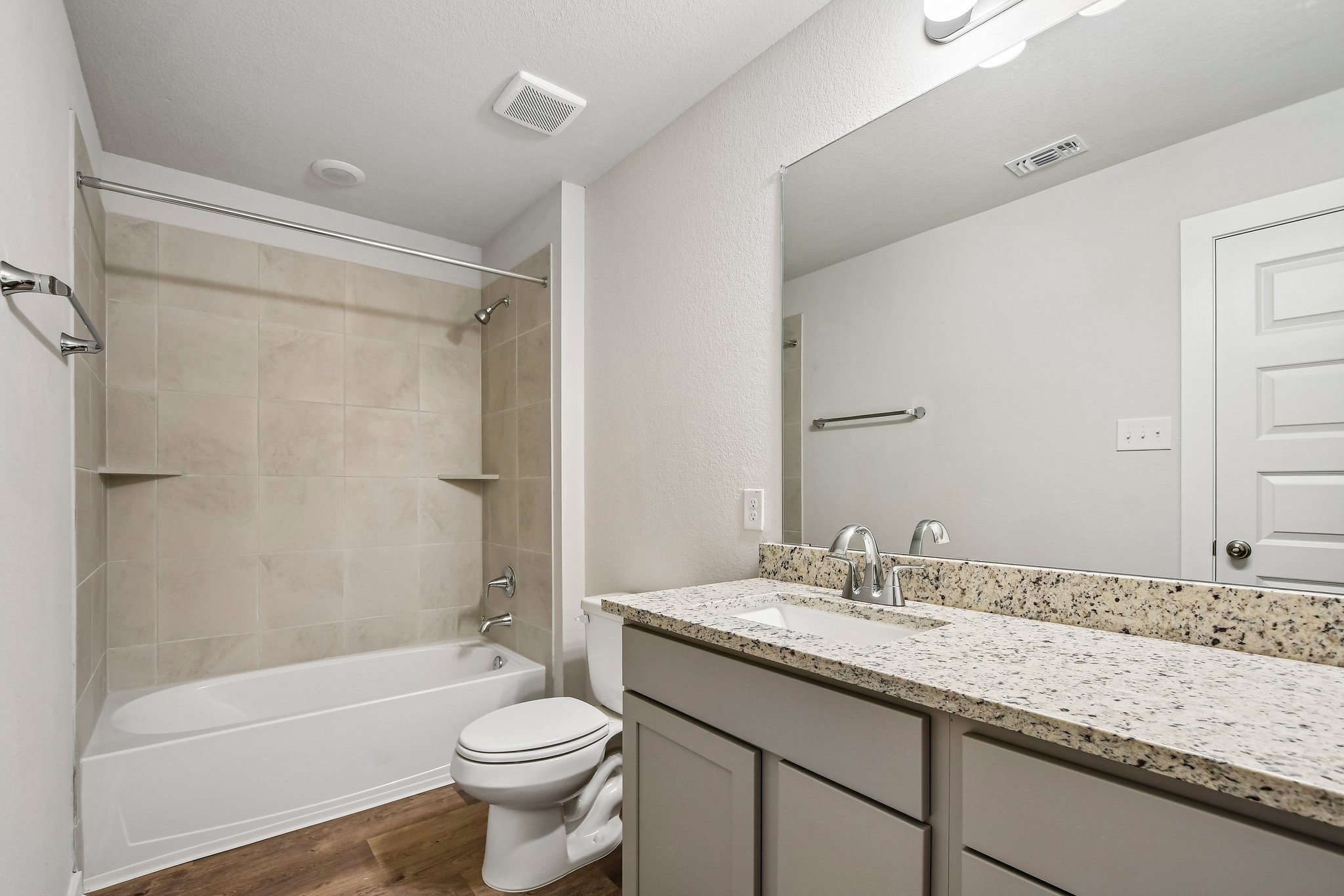 A bathroom with a marble countertop.