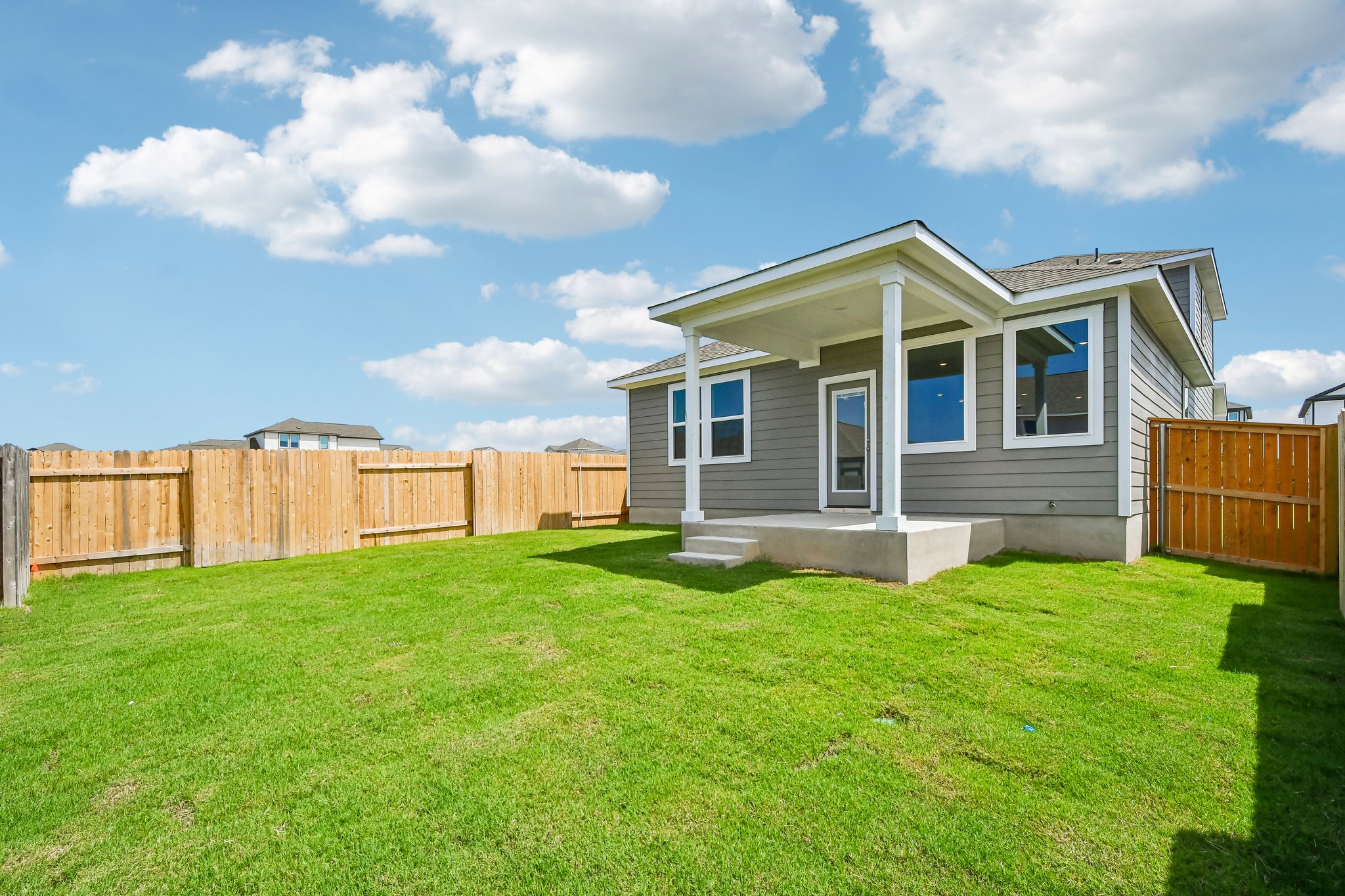 A house with a fence and grass.