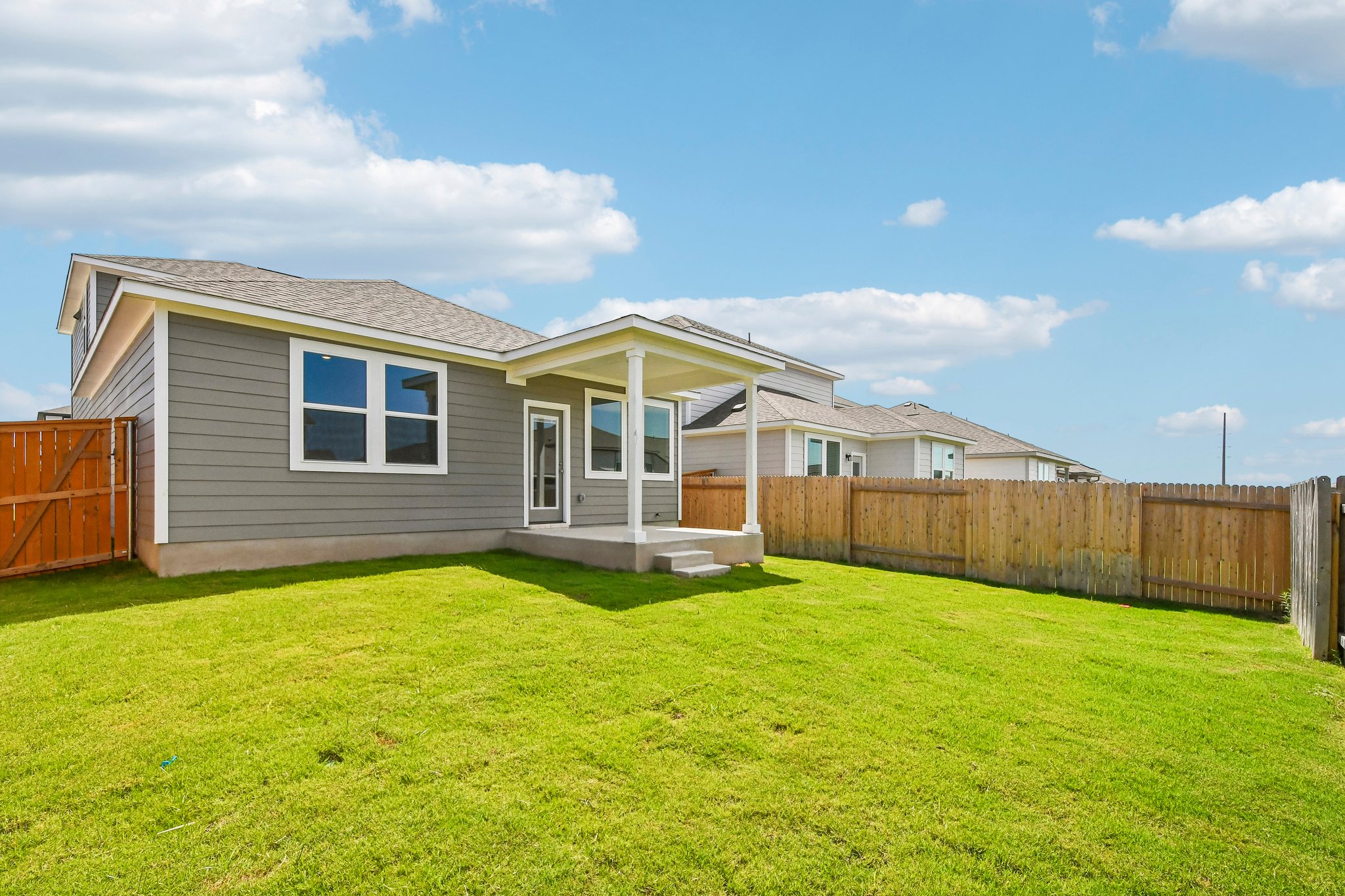 A house with a fence and grass.