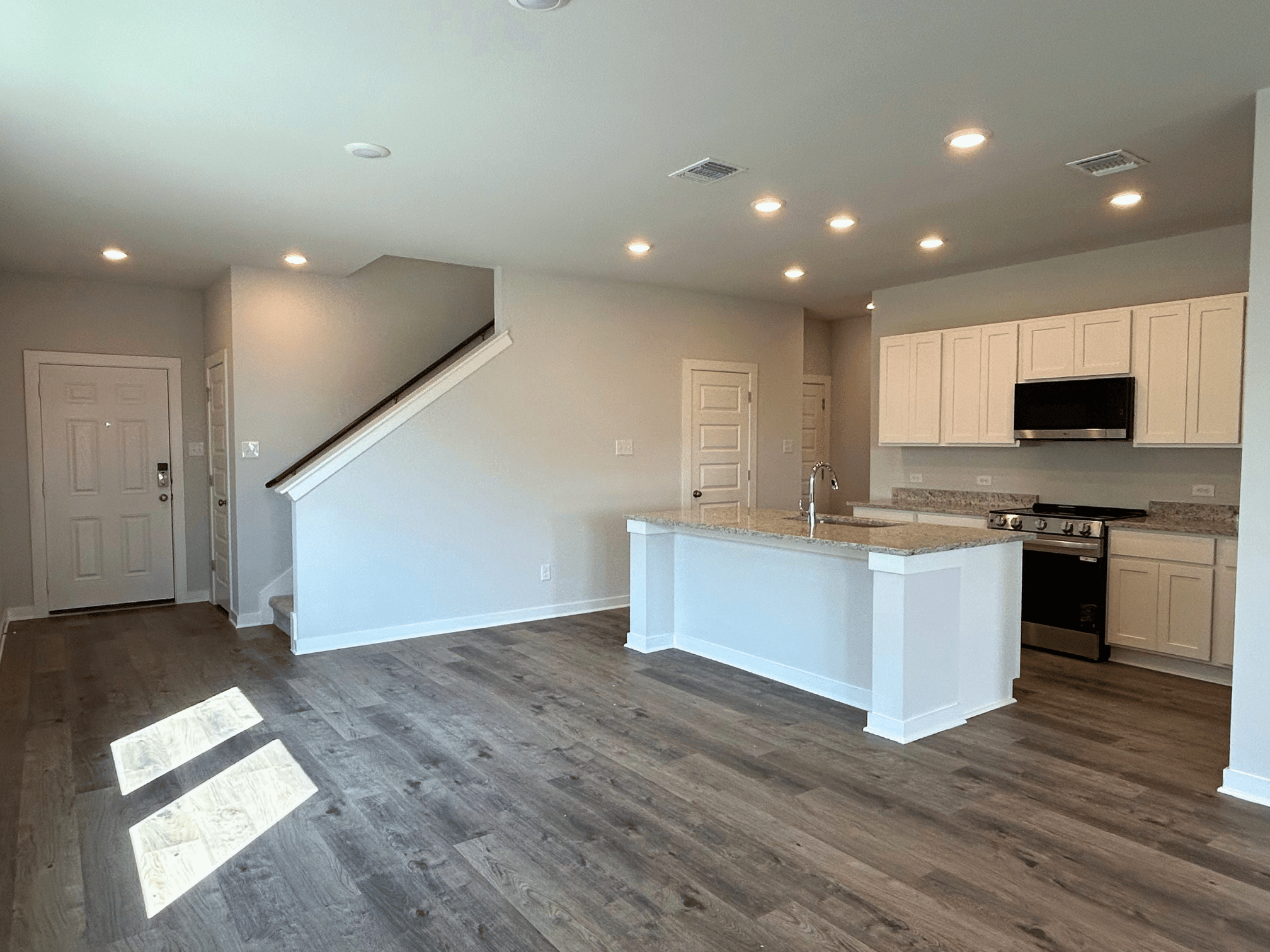 A kitchen with white cabinets.