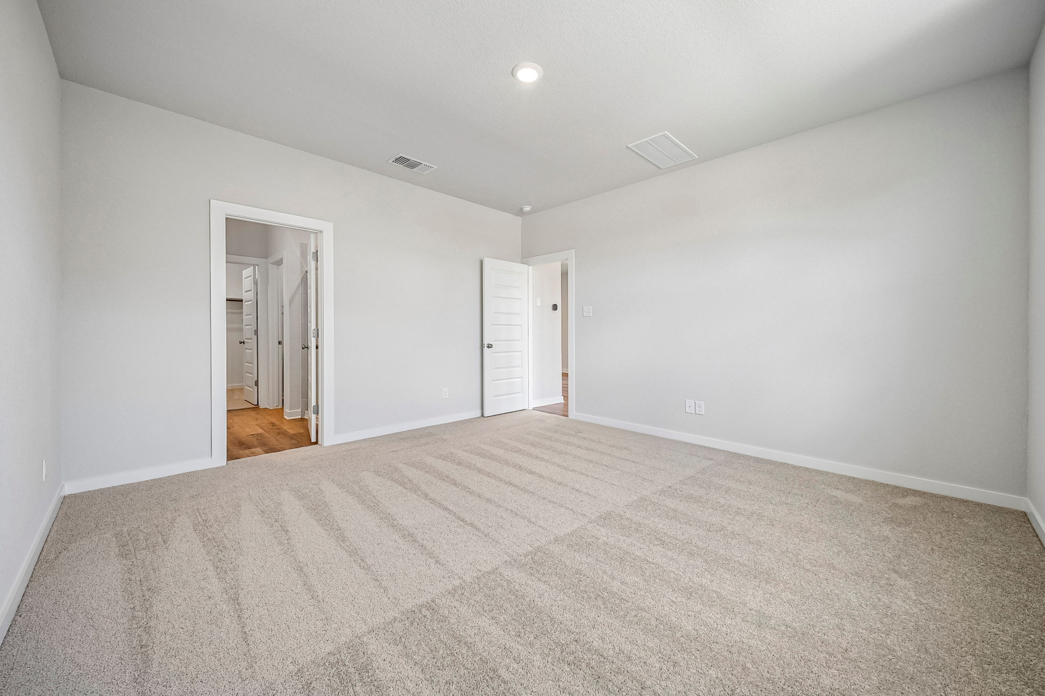 A hallway with white walls.