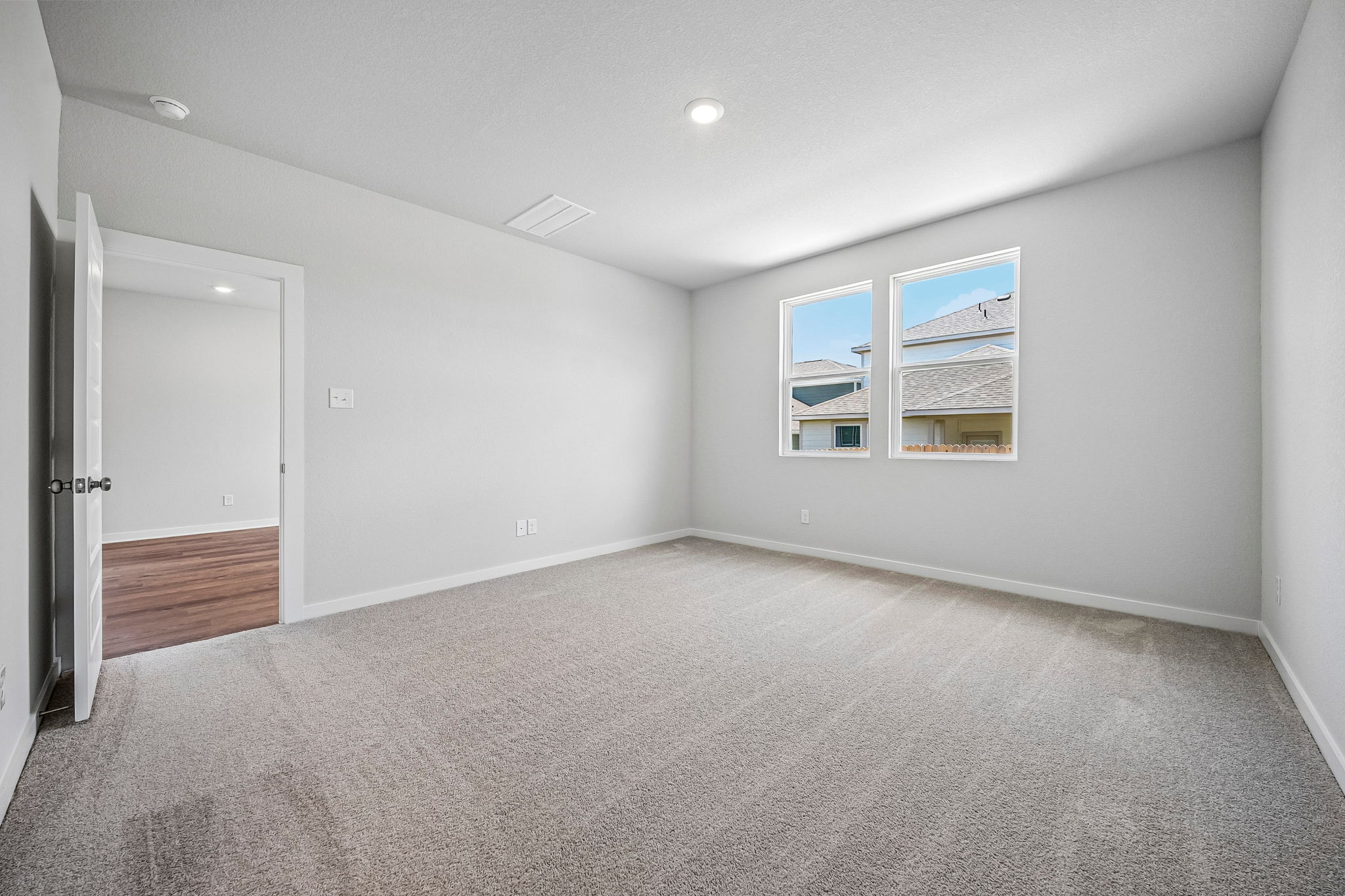A room with a carpet and a window.