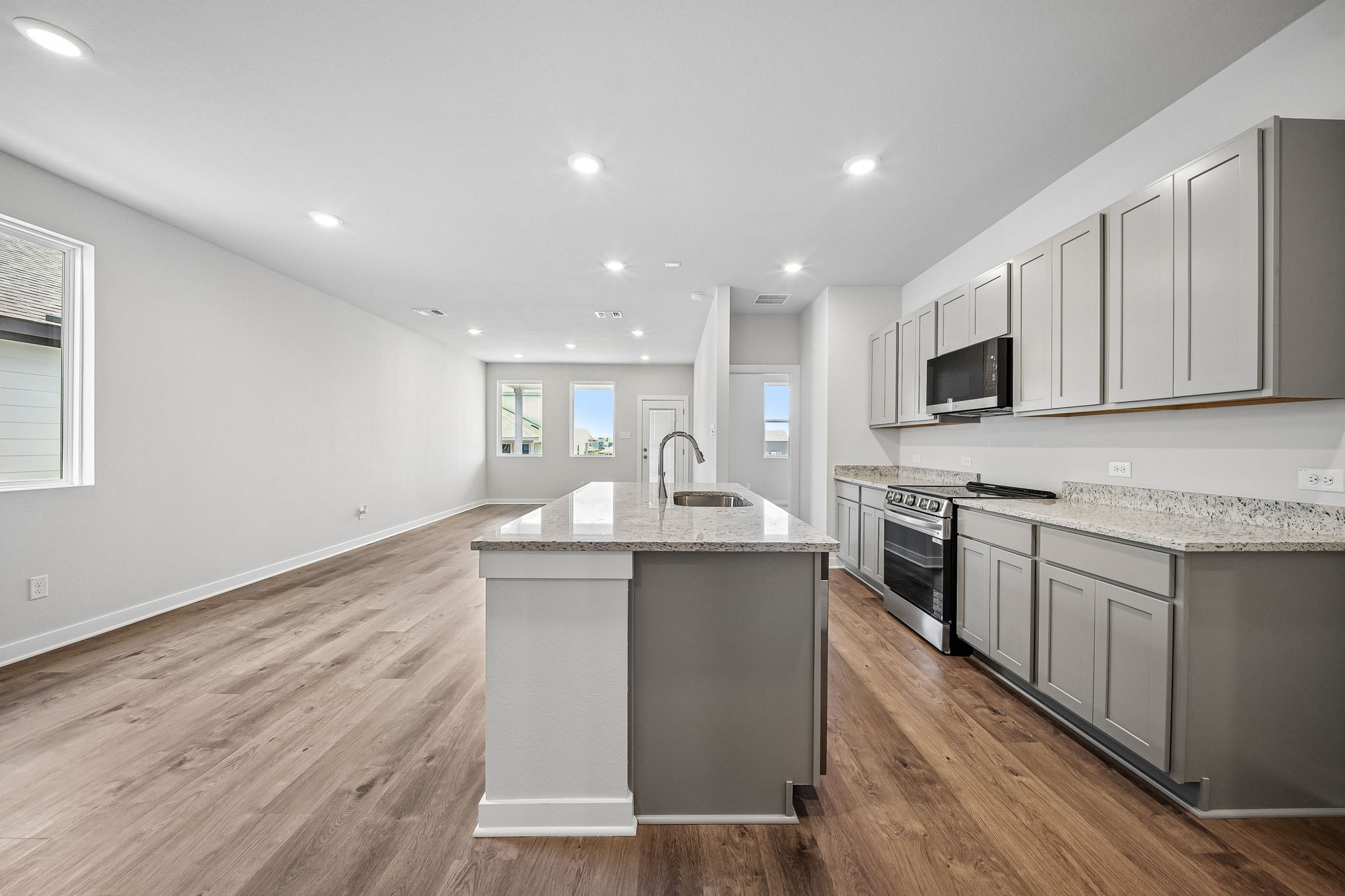 A kitchen with white cabinets.