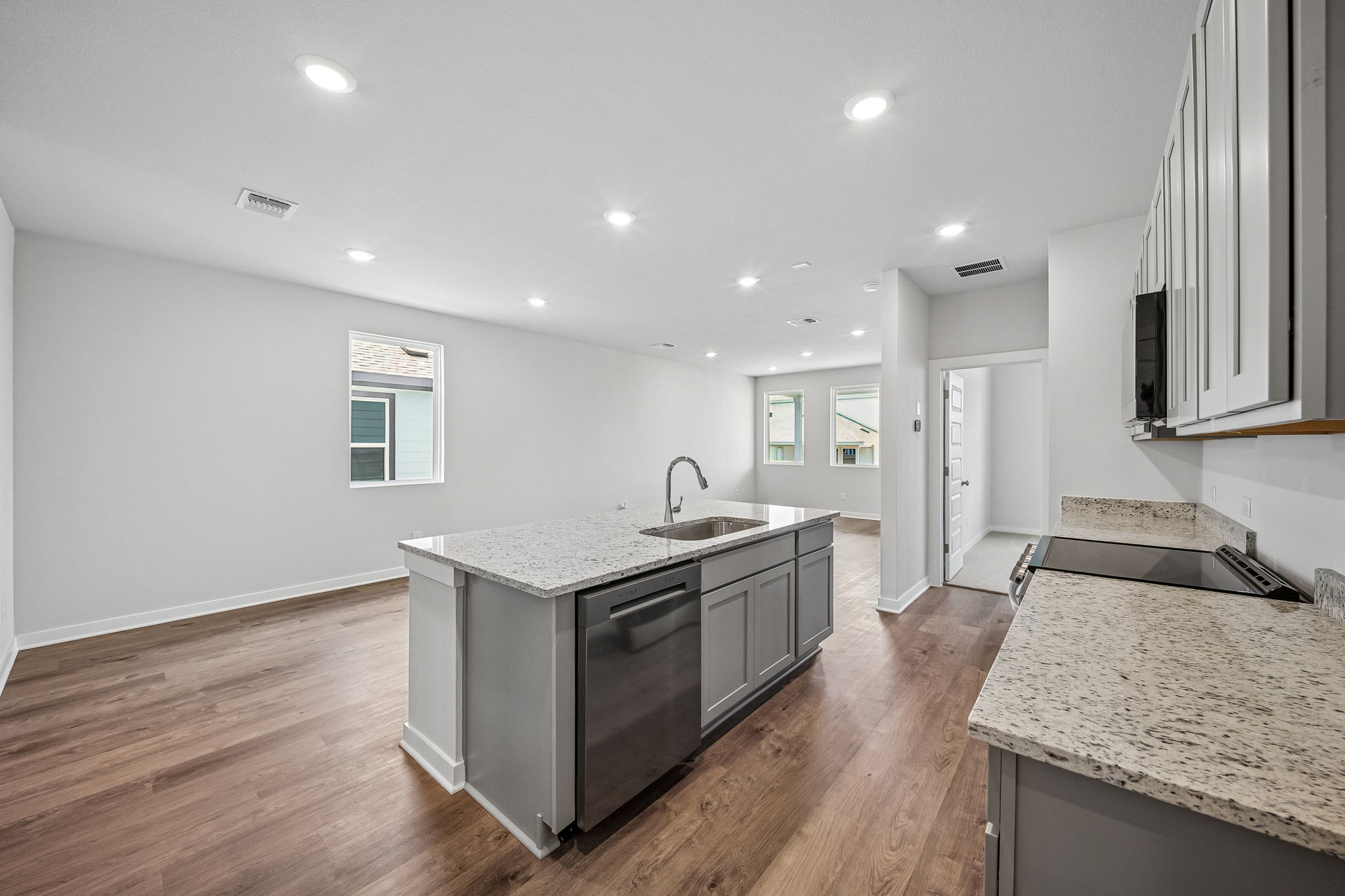 A kitchen with a wood floor.