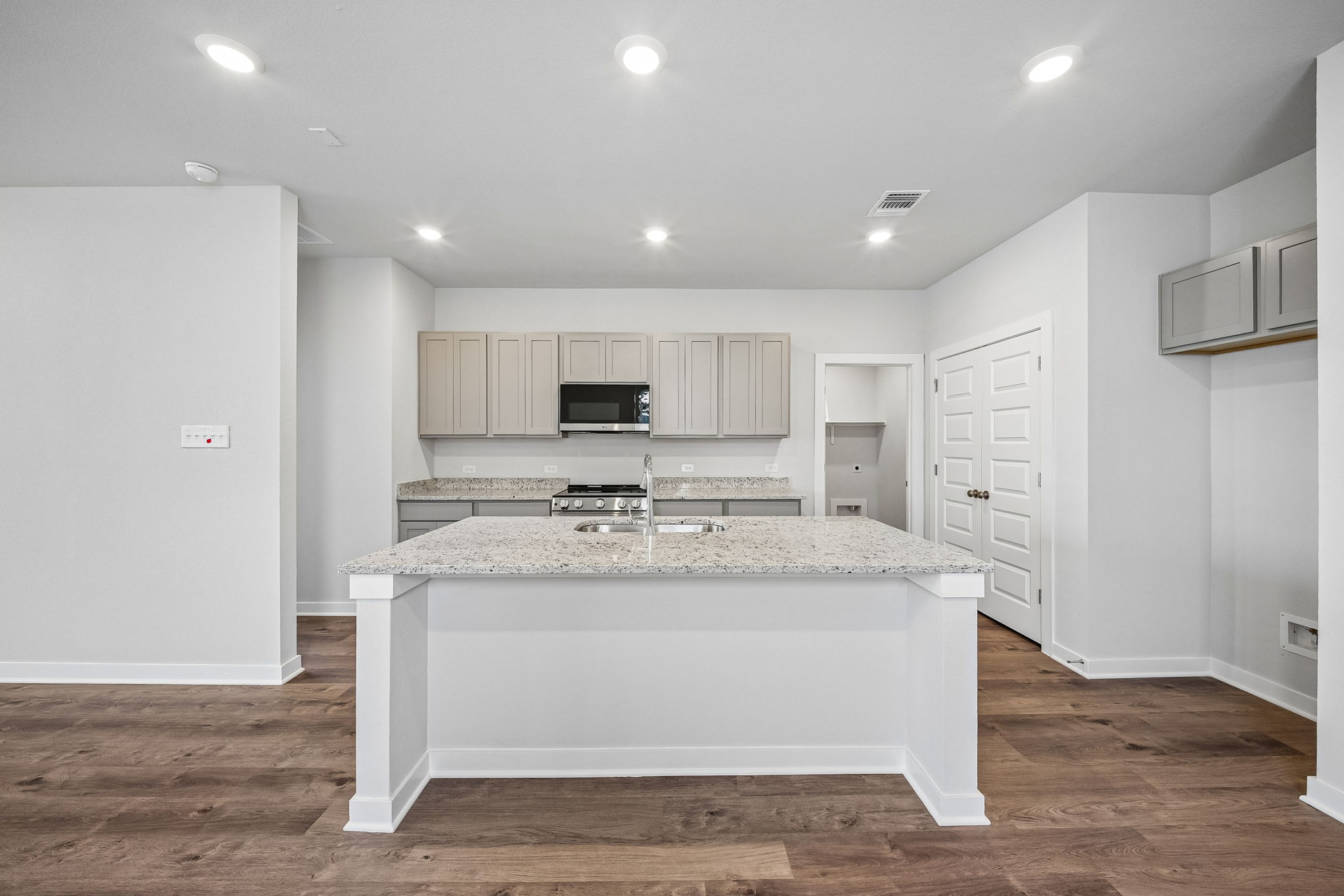 A large kitchen with white cabinets.