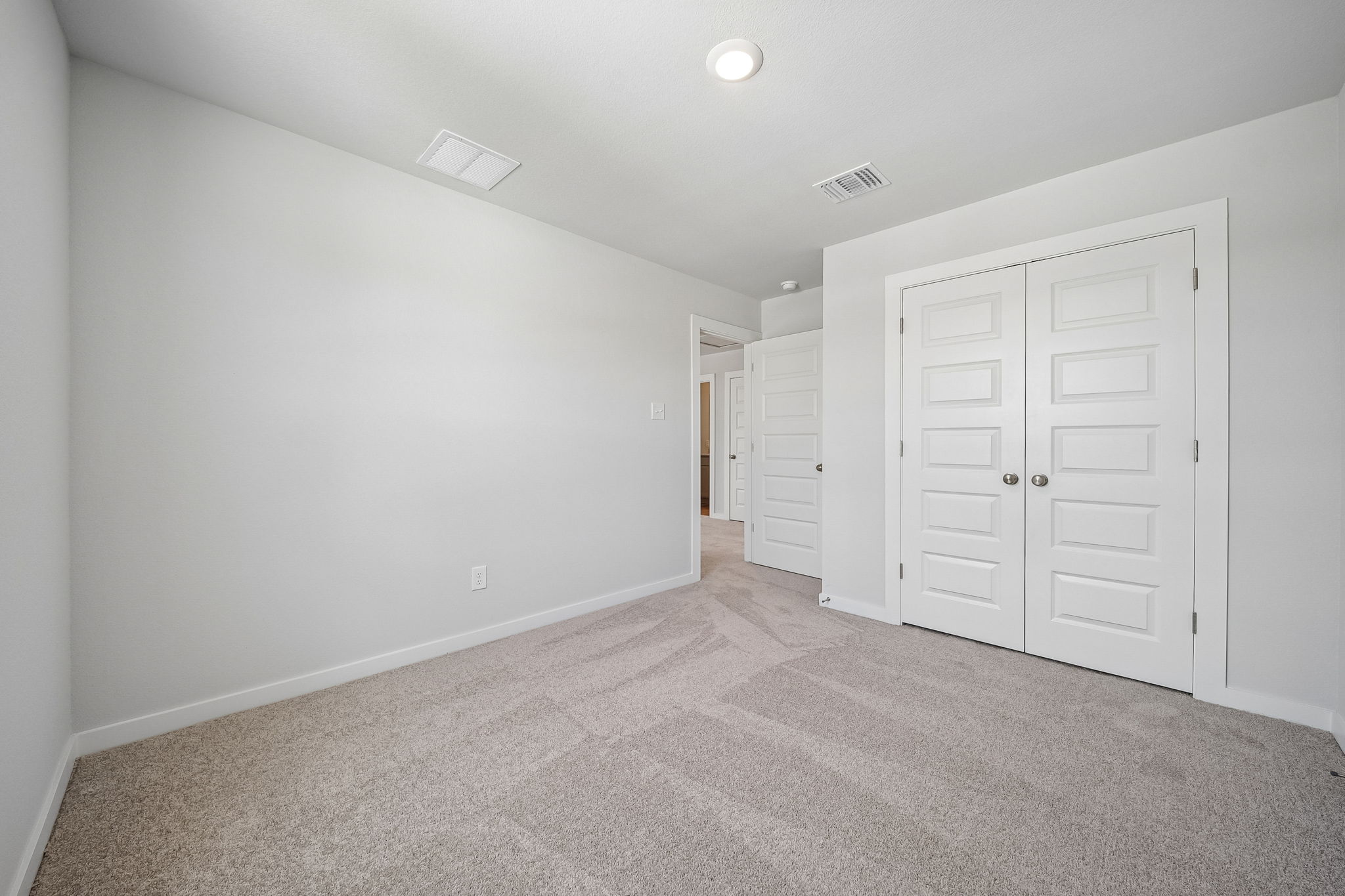 A hallway with white doors.