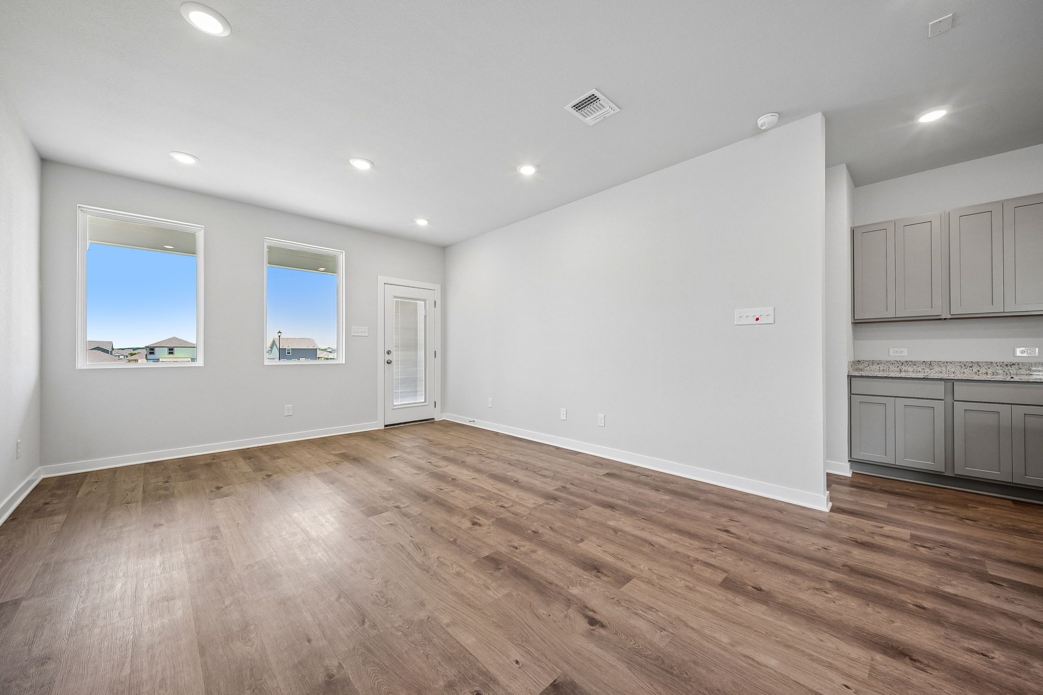 A room with white walls and a wood floor.